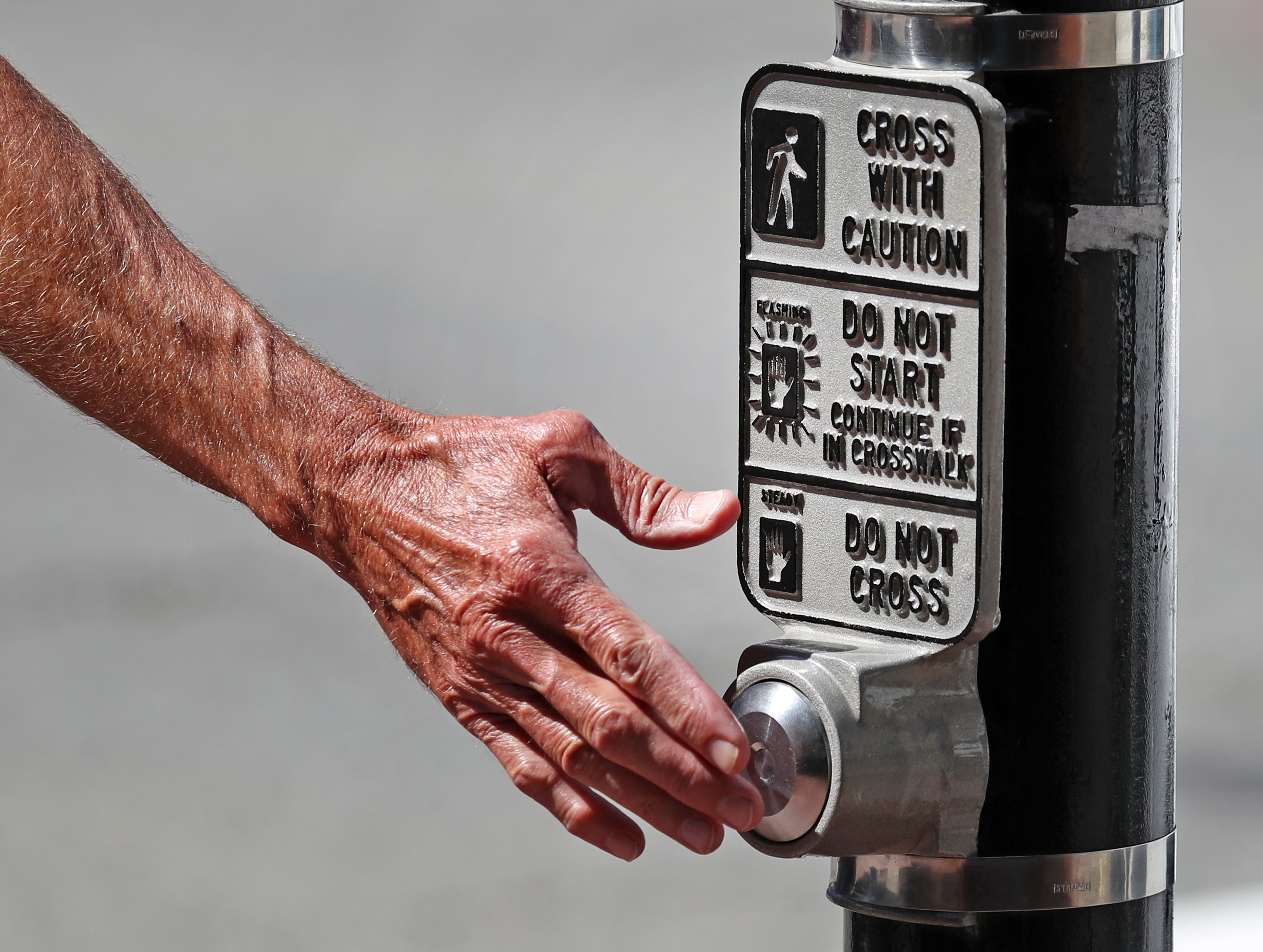 The vast majority of pedestrian buttons in downtown Boston neighborhoods don’t actually do anything — by design.