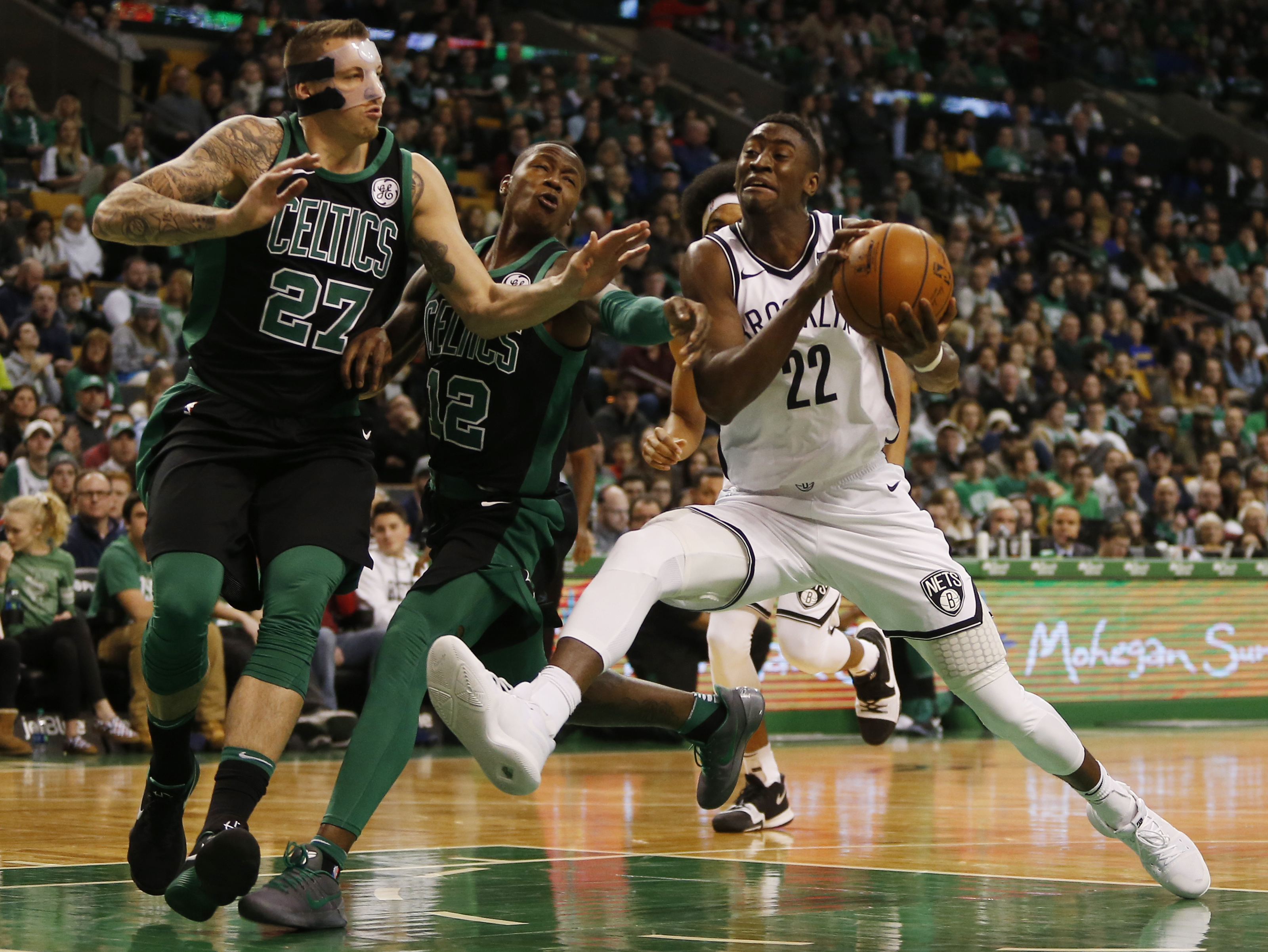 Caris LeVert (22), here challenging Daniel Theis and Terry Rozier III, has emerged as a dependable scorer for the Nets after he was acquired from Indiana on draft night in 2016.