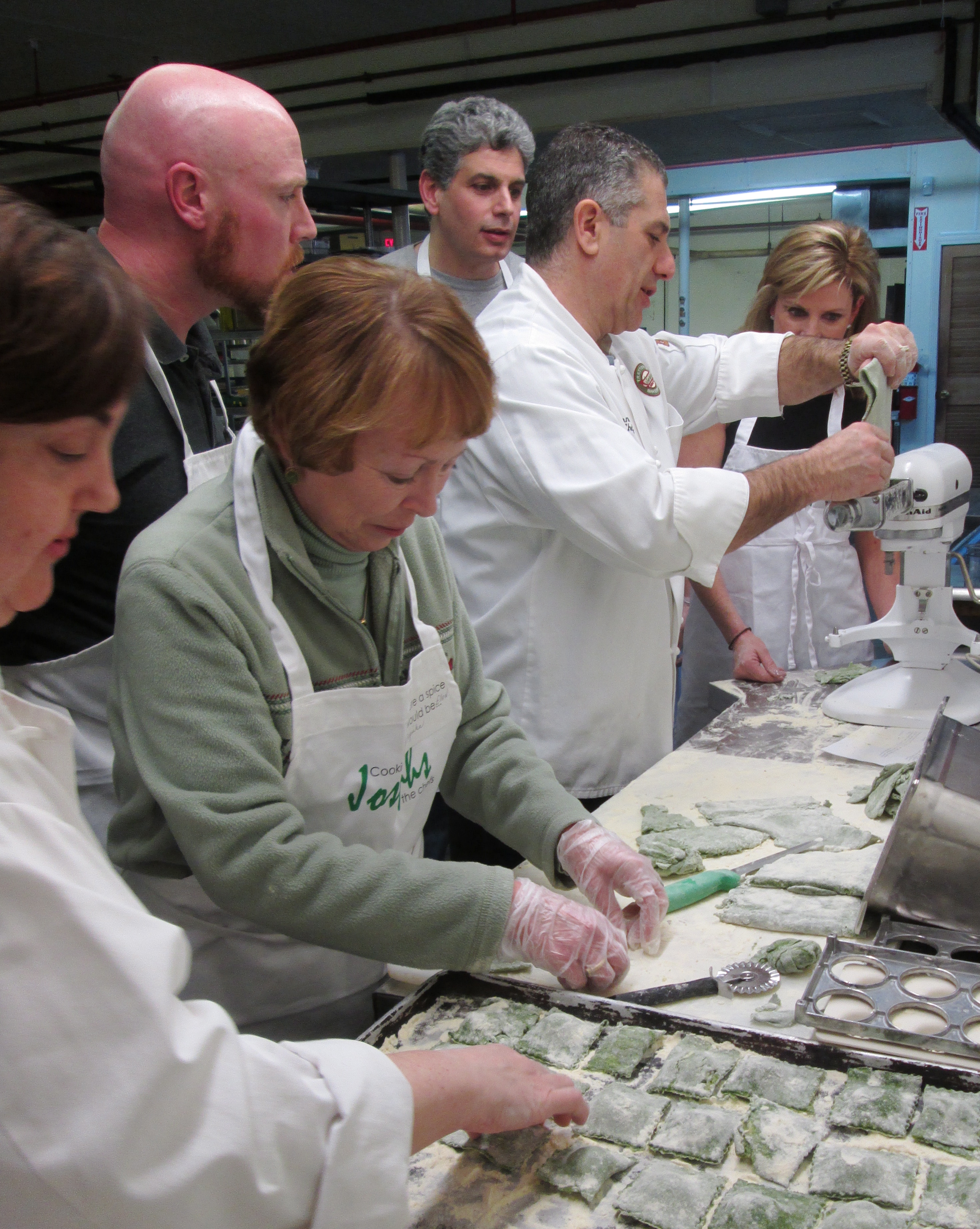 Rob Ozoonian and fellow chef Debra Stewart (far left) share pasta-making tips with (from right) Debbie Lucci, Jeff Quaglietta, and Ellen Prokop and her son, Matthew.