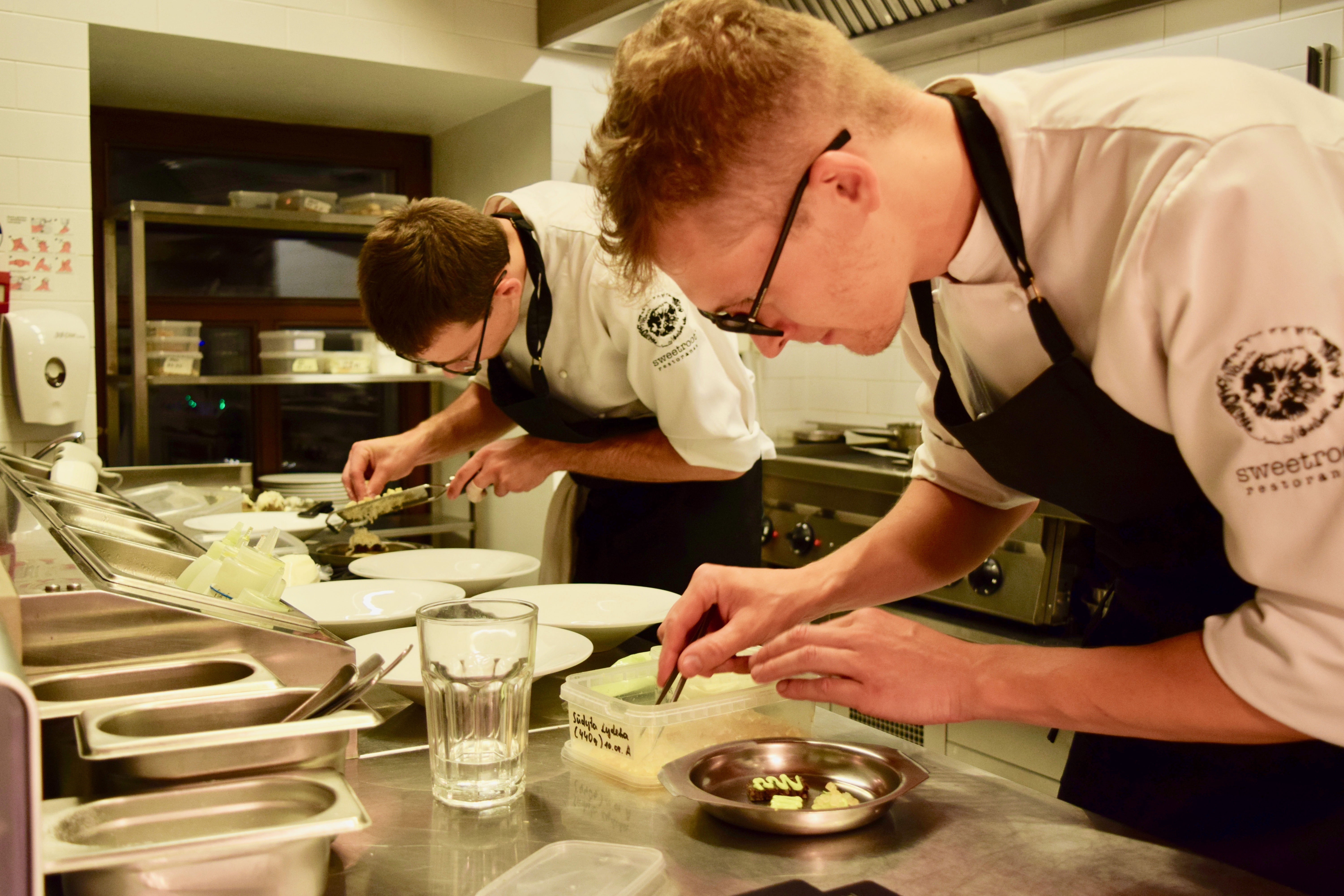 Chefs prepare a meal at Sweet Root restaurant in Vilnius, Lithuania.