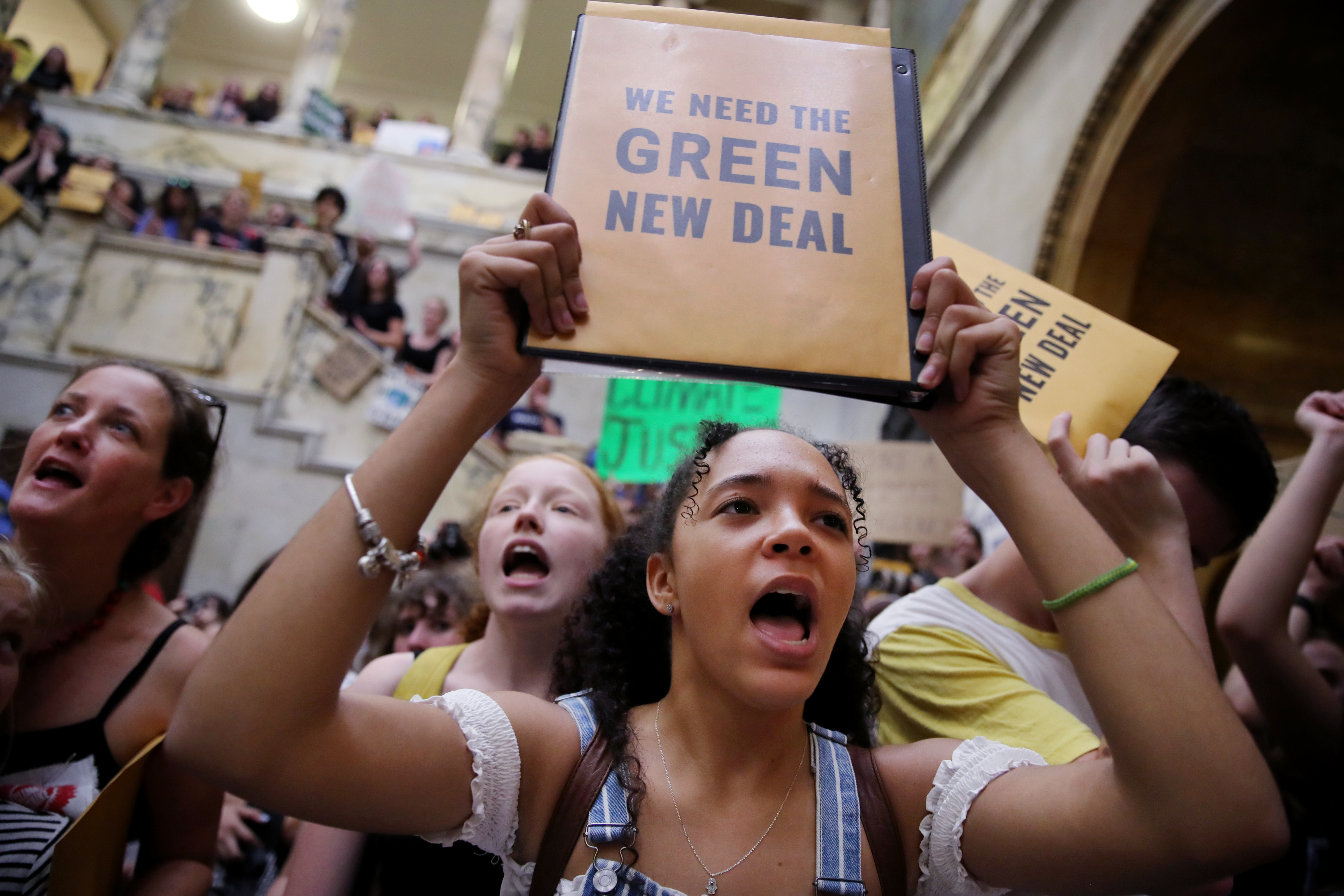 Alaysia Penso, 18, a freshman at Brandeis University joined in a chant at the State House.