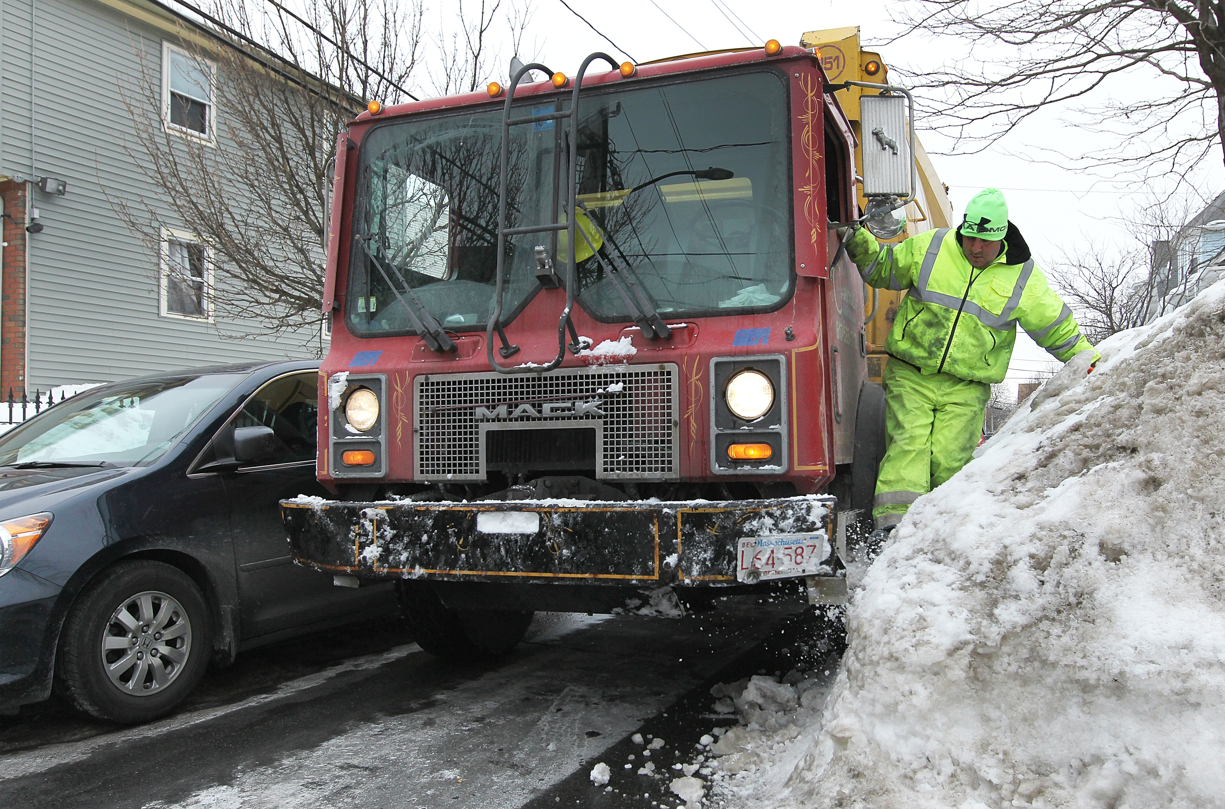 Capital Waste Services driver Angelo Santostefano tried to clear part of a snowbank on Bakersfield Street.