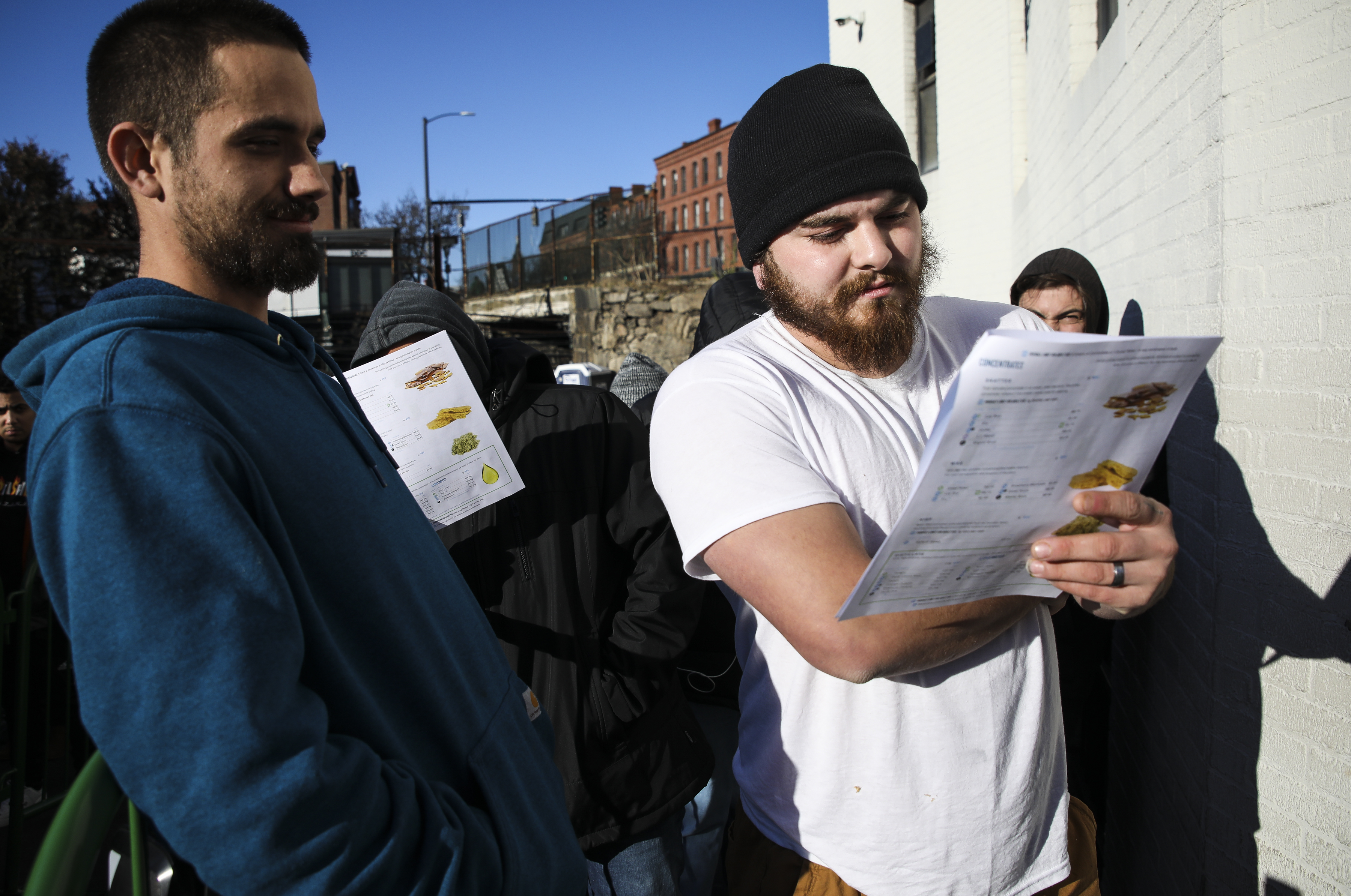Jacob Trevina looked at the menu while deciding what marijuana to purchase at New England Treatment Access in Brookline on Saturday.