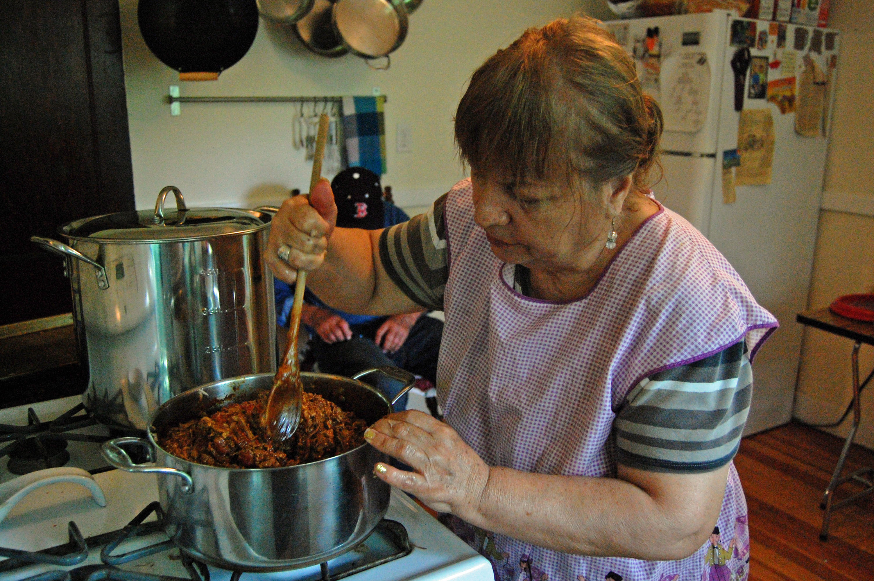 Felix prepares her shredded pork mixture for the tamales.