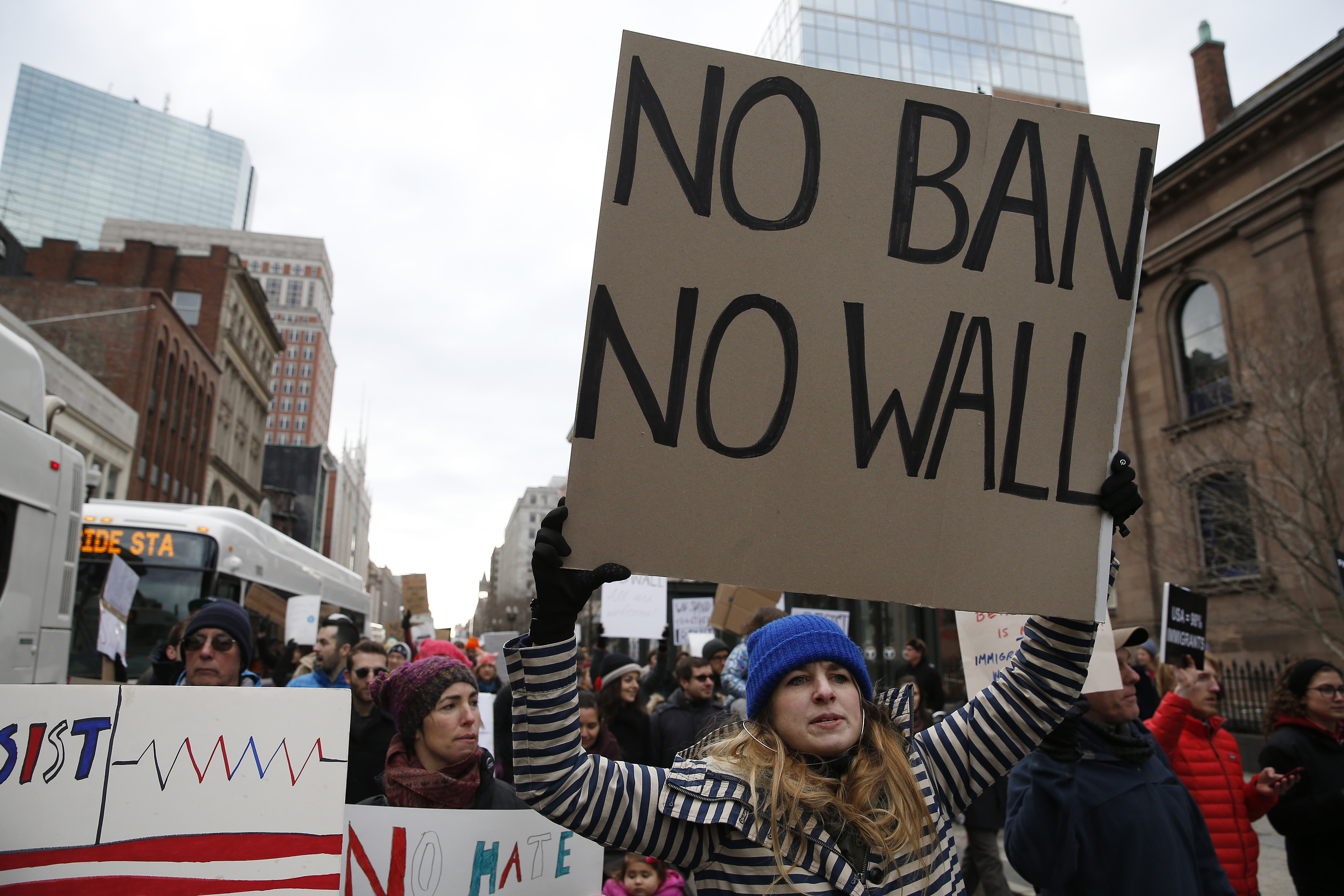 Rachel McClain, of Cambridge, carried a sign as she marched from Copley Square to the State House.