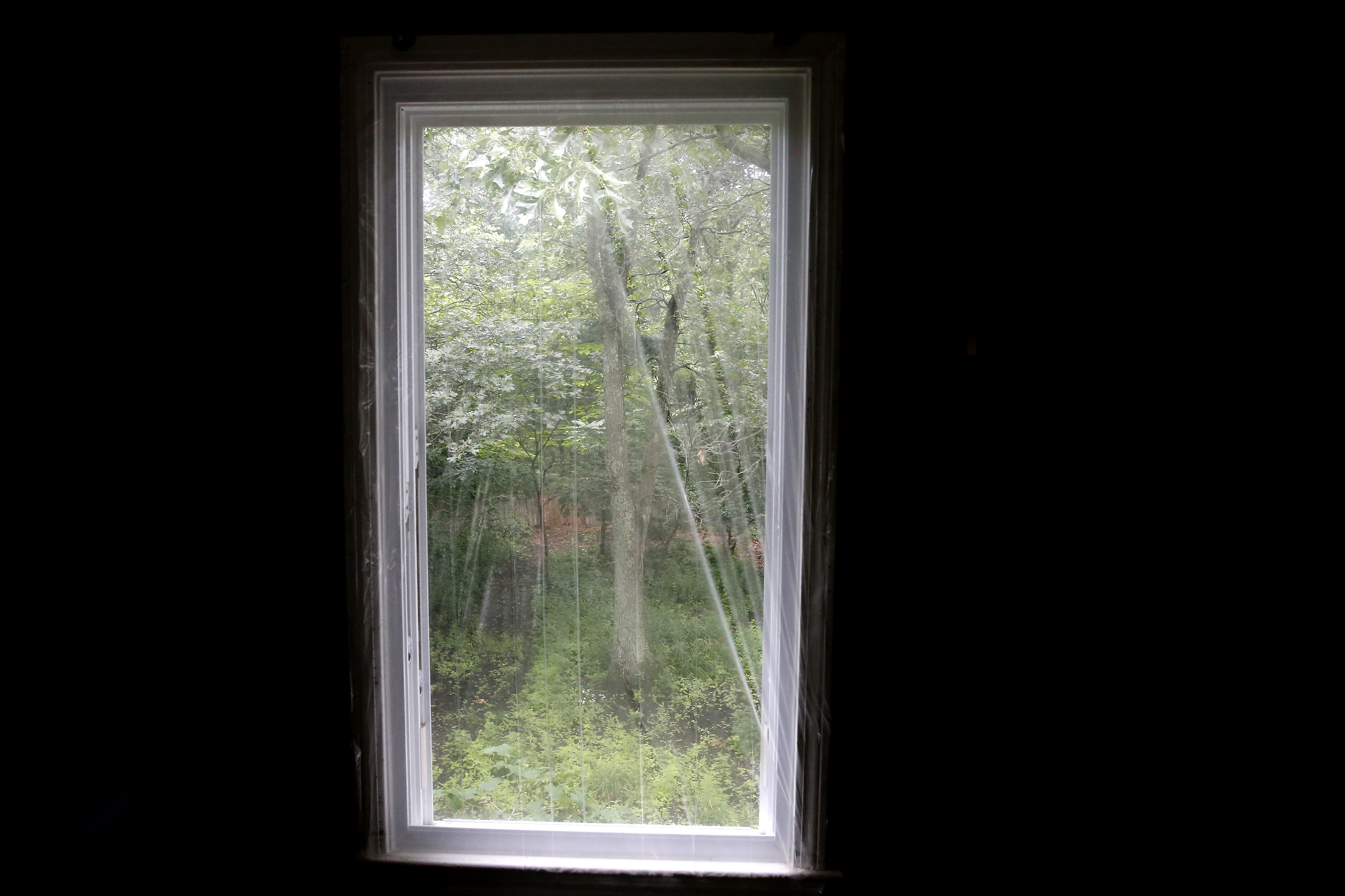 A window was shrouded in plastic after a SWAT team broke it during a 10-hour standoff with Austin Reeves.