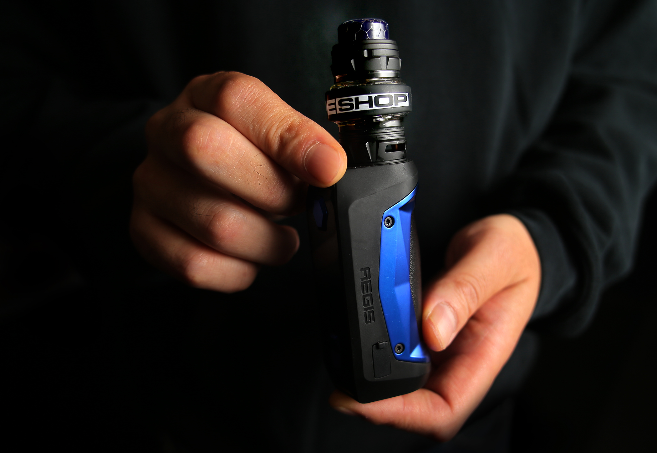 Owner Jonathan Lau of The Vape Shop held an ecigarette, the sale of which is now banned following Governor Charlie Baker’s announcement Tuesday.