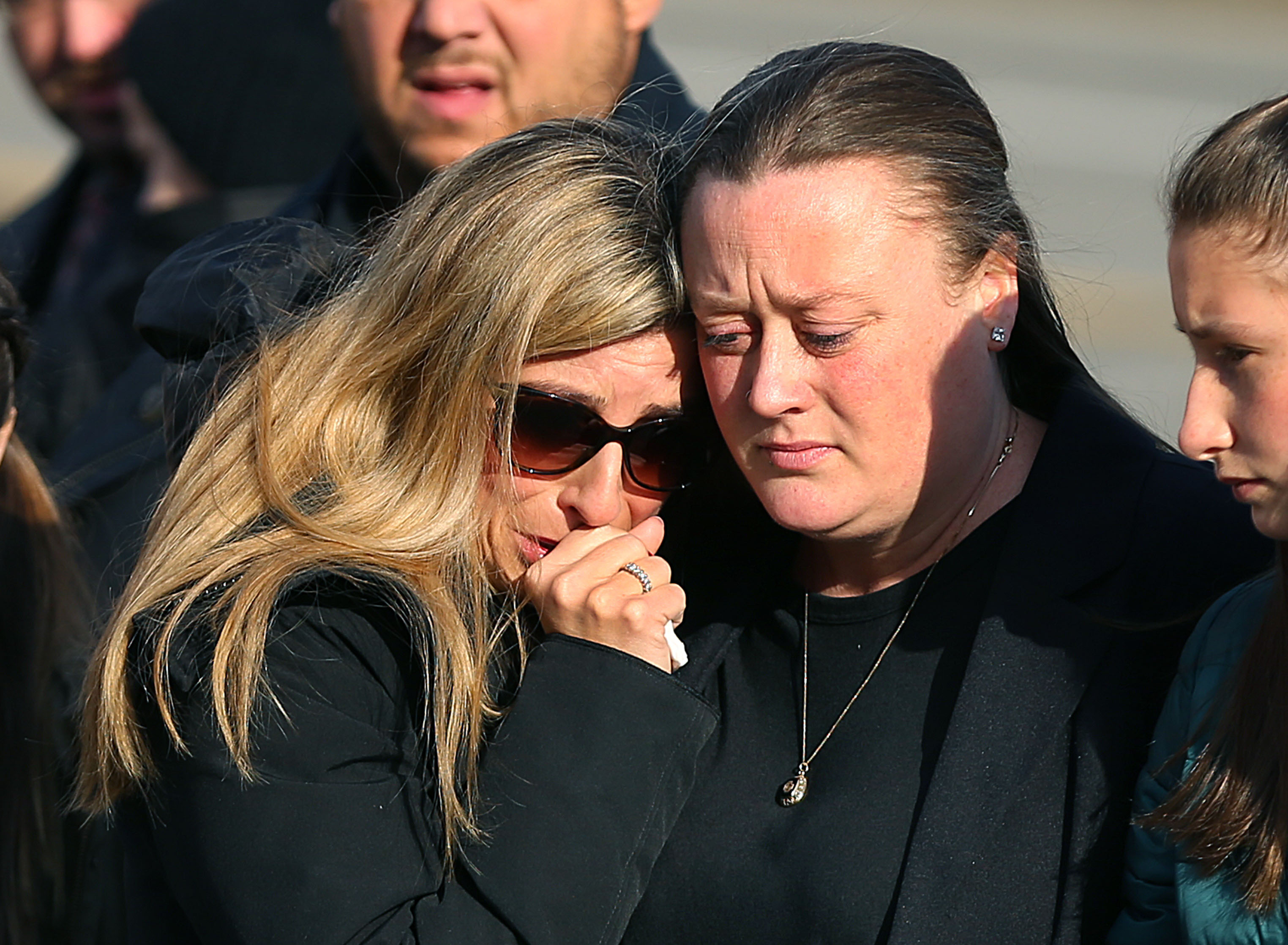 Fortini’s sister Joy Wilson and his fiance, Caitlin McGuire comforted each other.