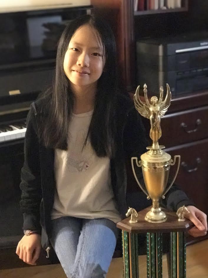 Joy Cao, 11, the Massachusetts 2017 Girl’s Champion with her trophy.