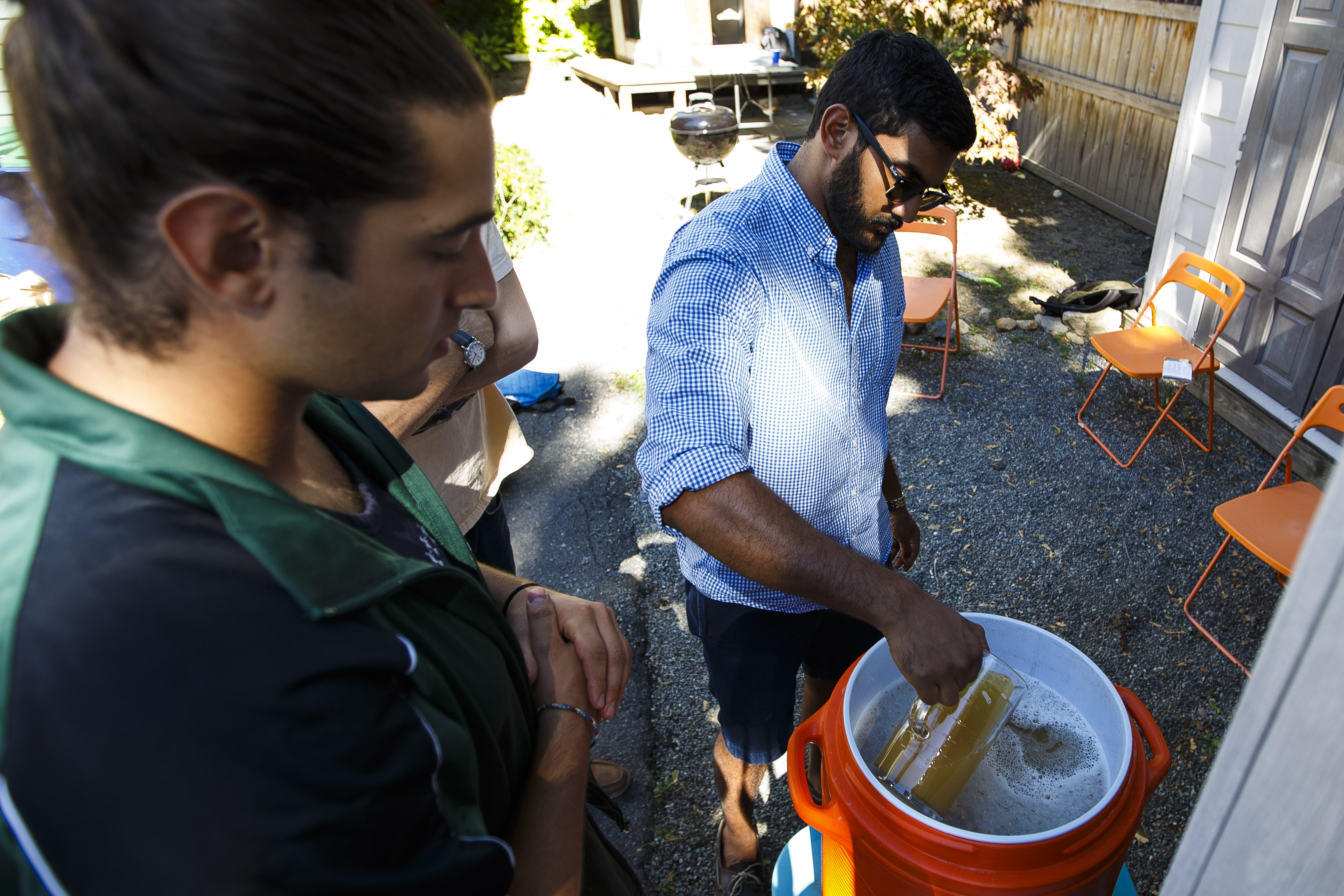 Teryn Citino (left) and Prakash Iyer filtered their beer during the brewing process.