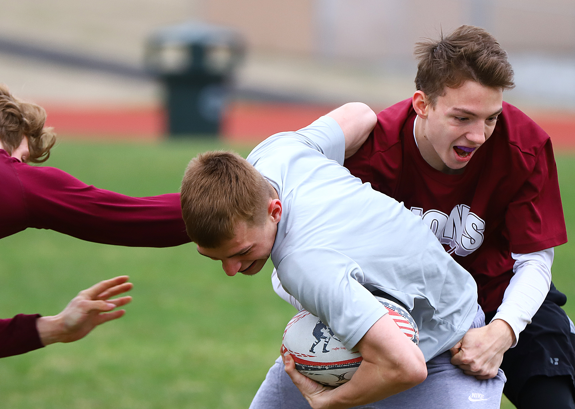 Jake Harrison takes down a teammate during rugby practice.