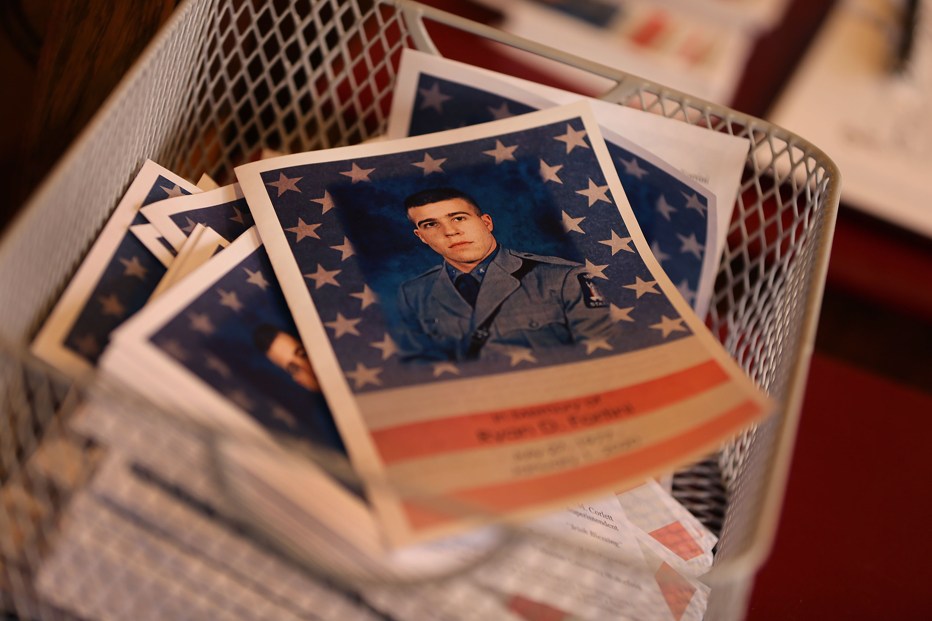 A funeral program sat in a basket at St. Margaret’s Church.