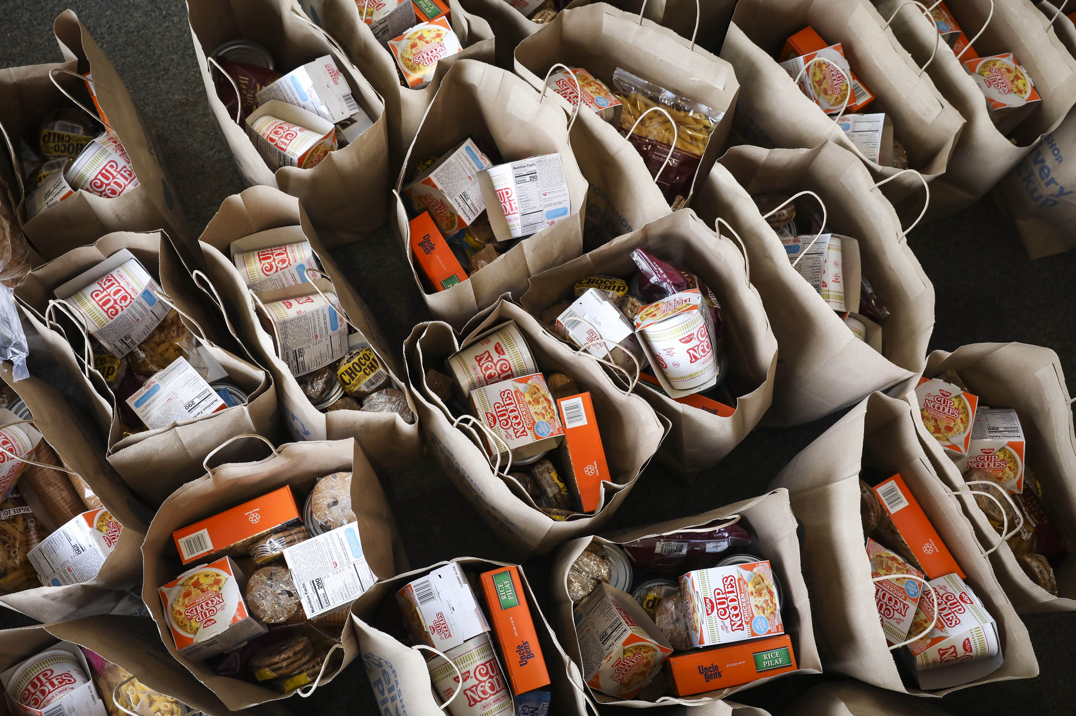 Bags of food waited to be loaded into vehicles to be delivered to students and families who may need it.