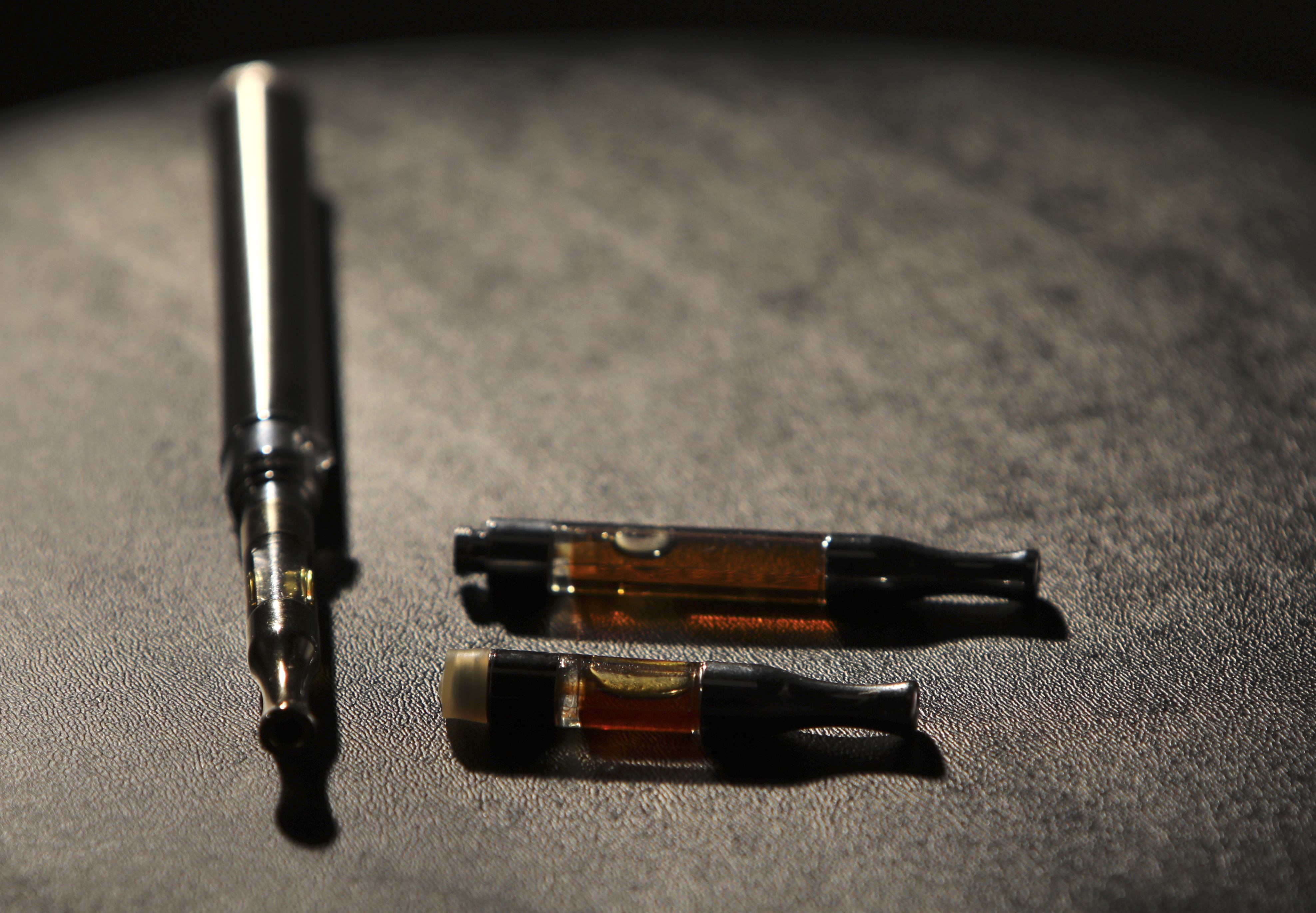 A vape pen and tobacco cartridges.