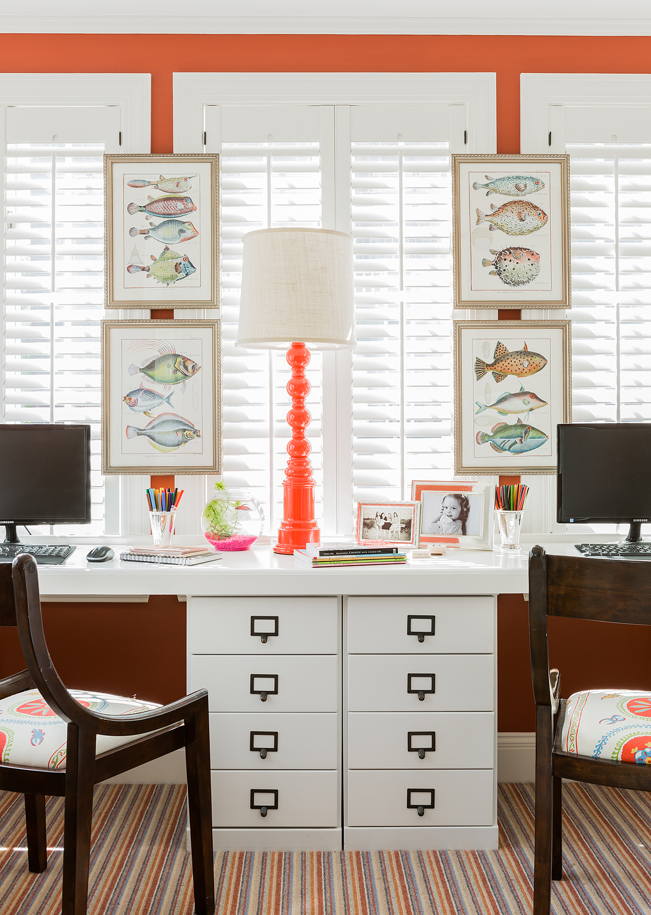 Designer Elizabeth Benedict turned a sunroom in her Chestnut Hill home into a kids work space complete with desks, matching monitors, and plenty of drawers.