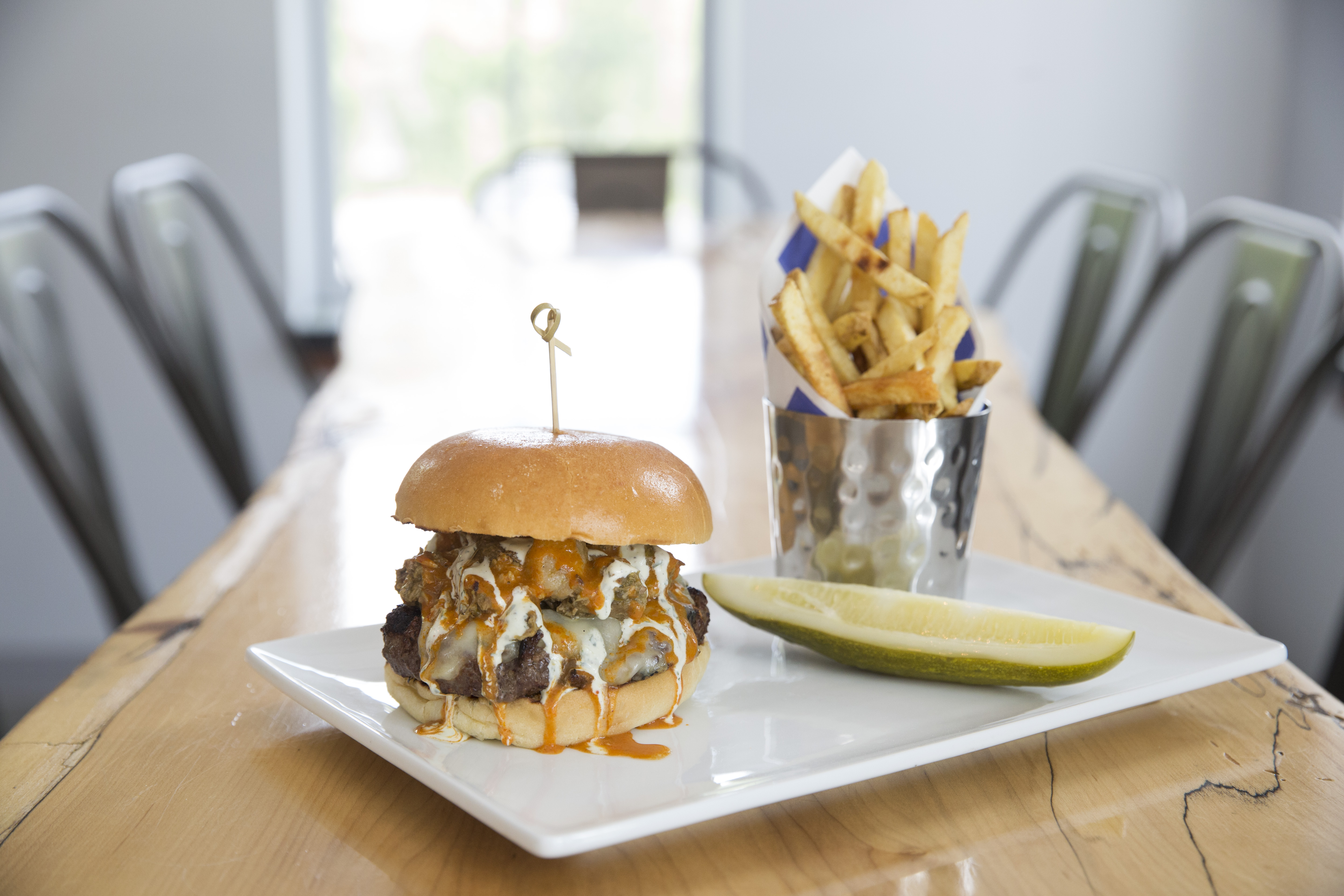 The Spicy Pig burger — with cheddar, hot sauce, and pork chili — and hand-cut fries.