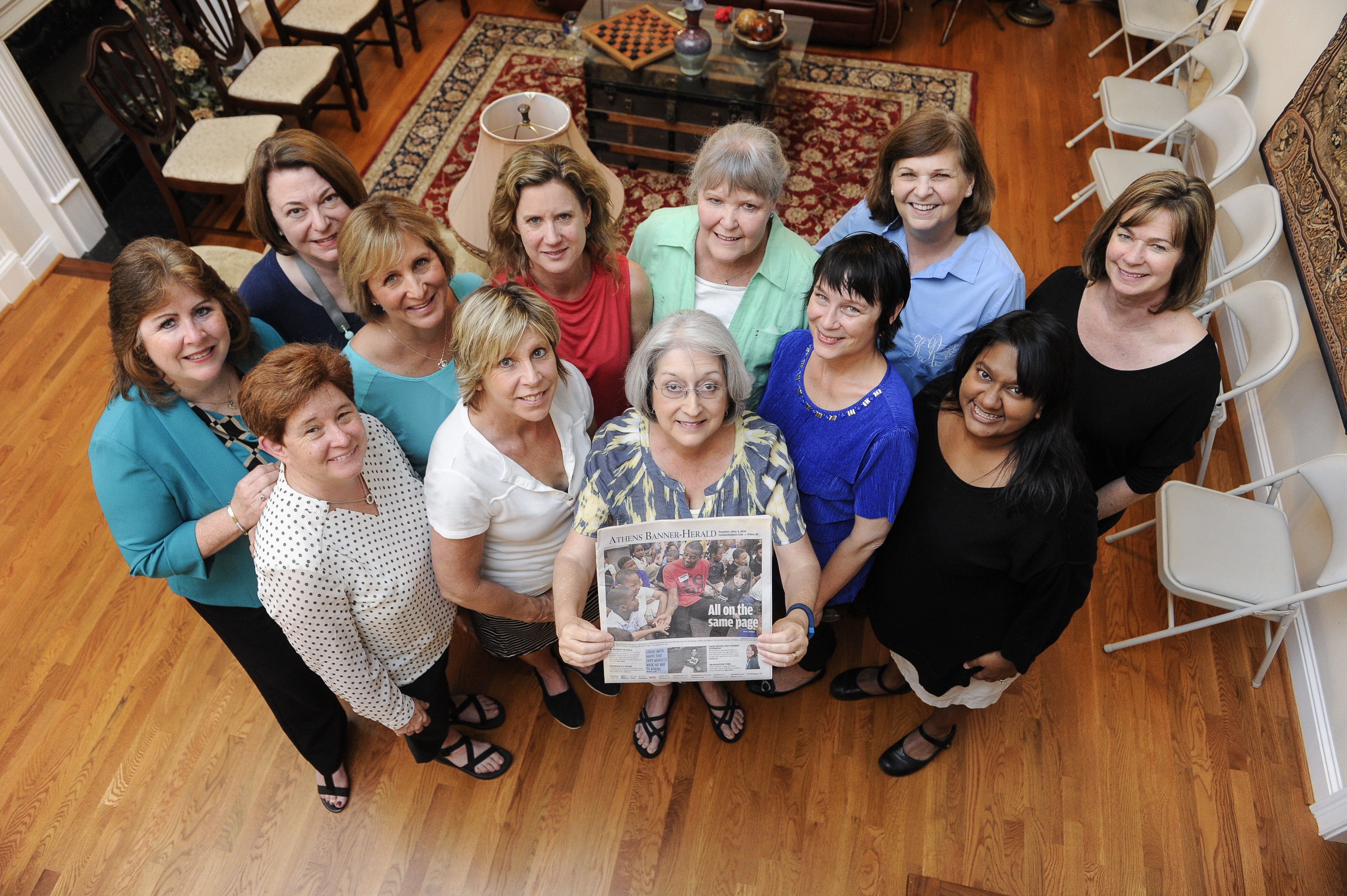 A book club member held up a local newspaper article featuring Malcolm Mitchell.