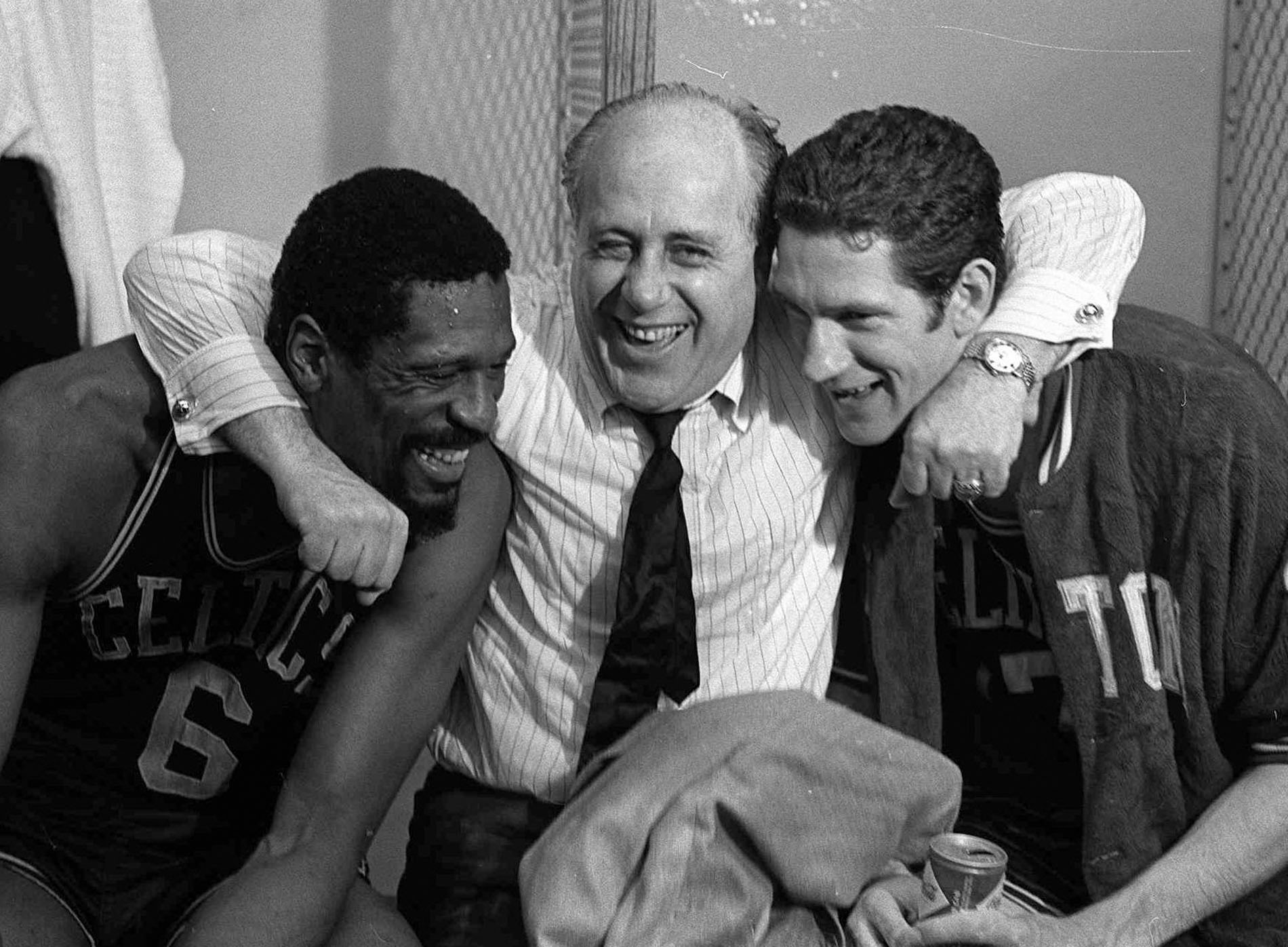 Havlicek (right), with teammate Bill Russell and coach Red Auerbach after the Celtics defeated the Lakers in the 1968 finals.