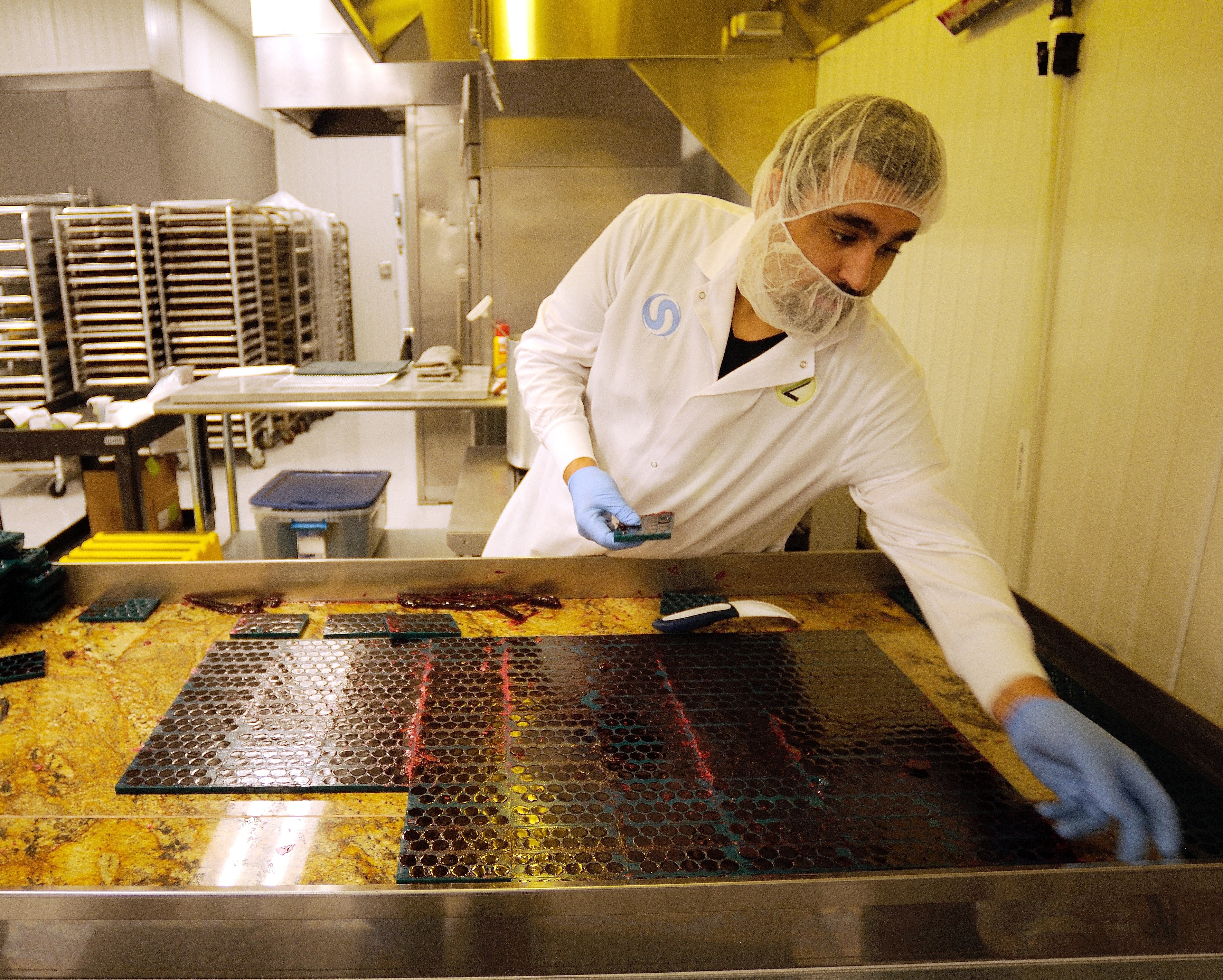 Production lead John Decker removed candy molds filled with finished nuggets at the Zoots marijuana edibles production facility in Denver.