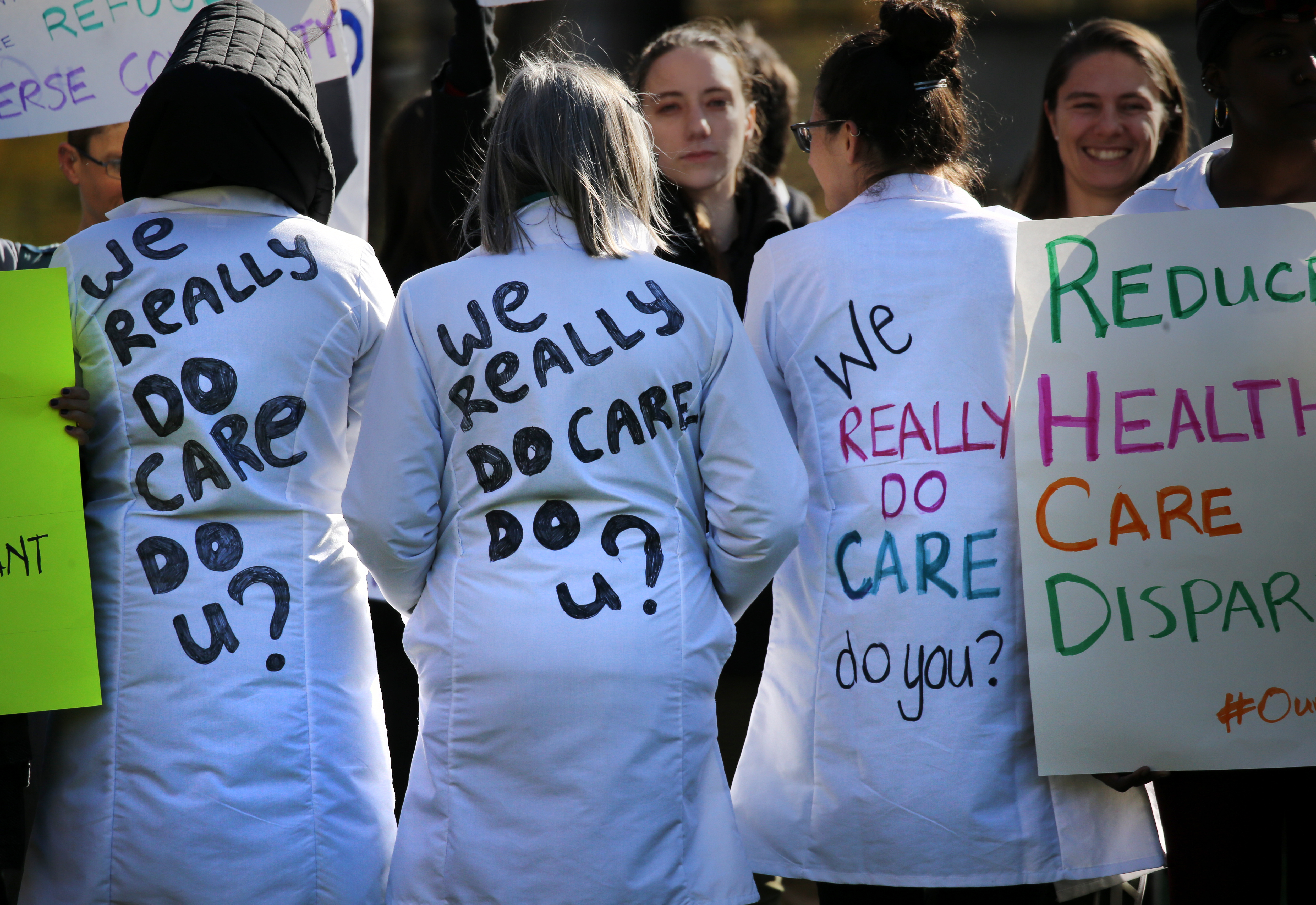 Several demonstrators wore lab coats with the words “We really do care, do u?” written on the back, a reference to a jacket with the phrase “I really don’t care, do u?” the first lady wore last year during a visit to Texas.