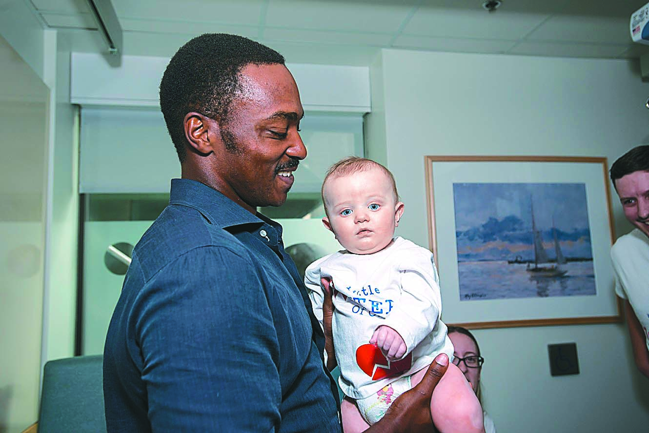 Anthony Mackie and 9-month-old Carson Stenson at MassGeneral Hospital for Children.
