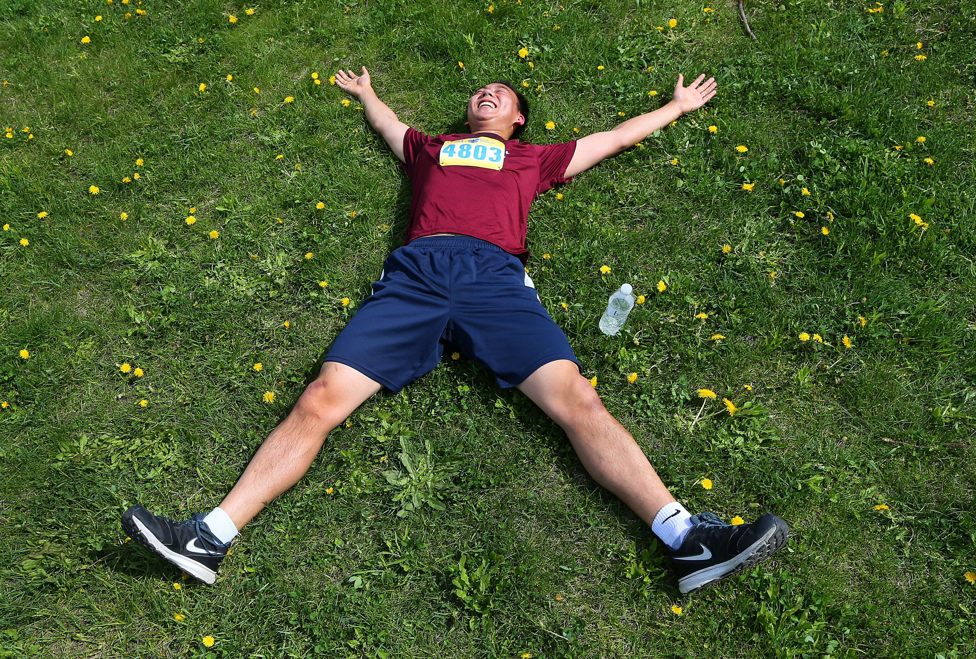 . Simon Zheng sprawled out after finishing the 5K.