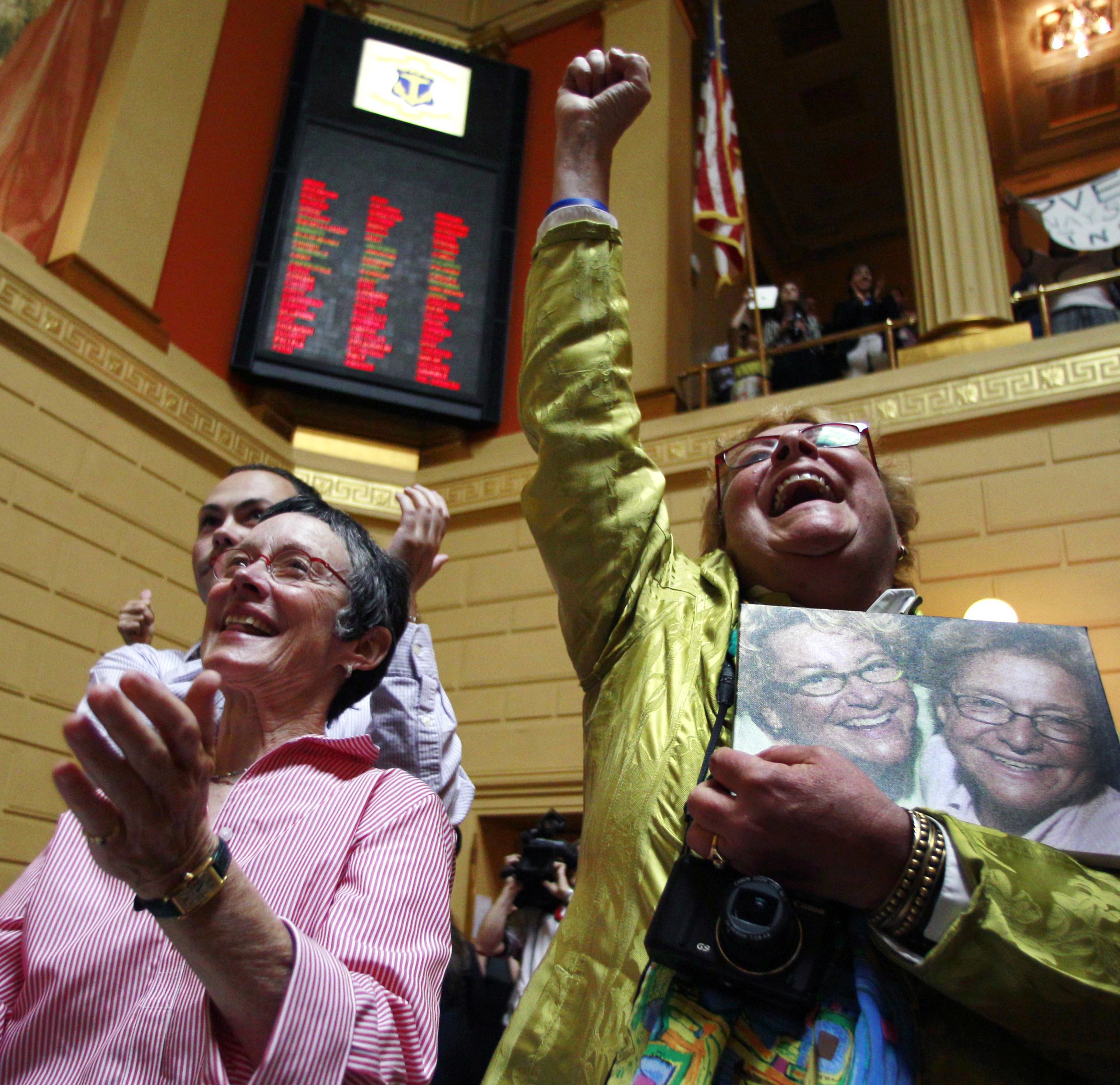 Lise Iwon (right) and Julie Smith celebrated after the gay marriage bill won final approval.