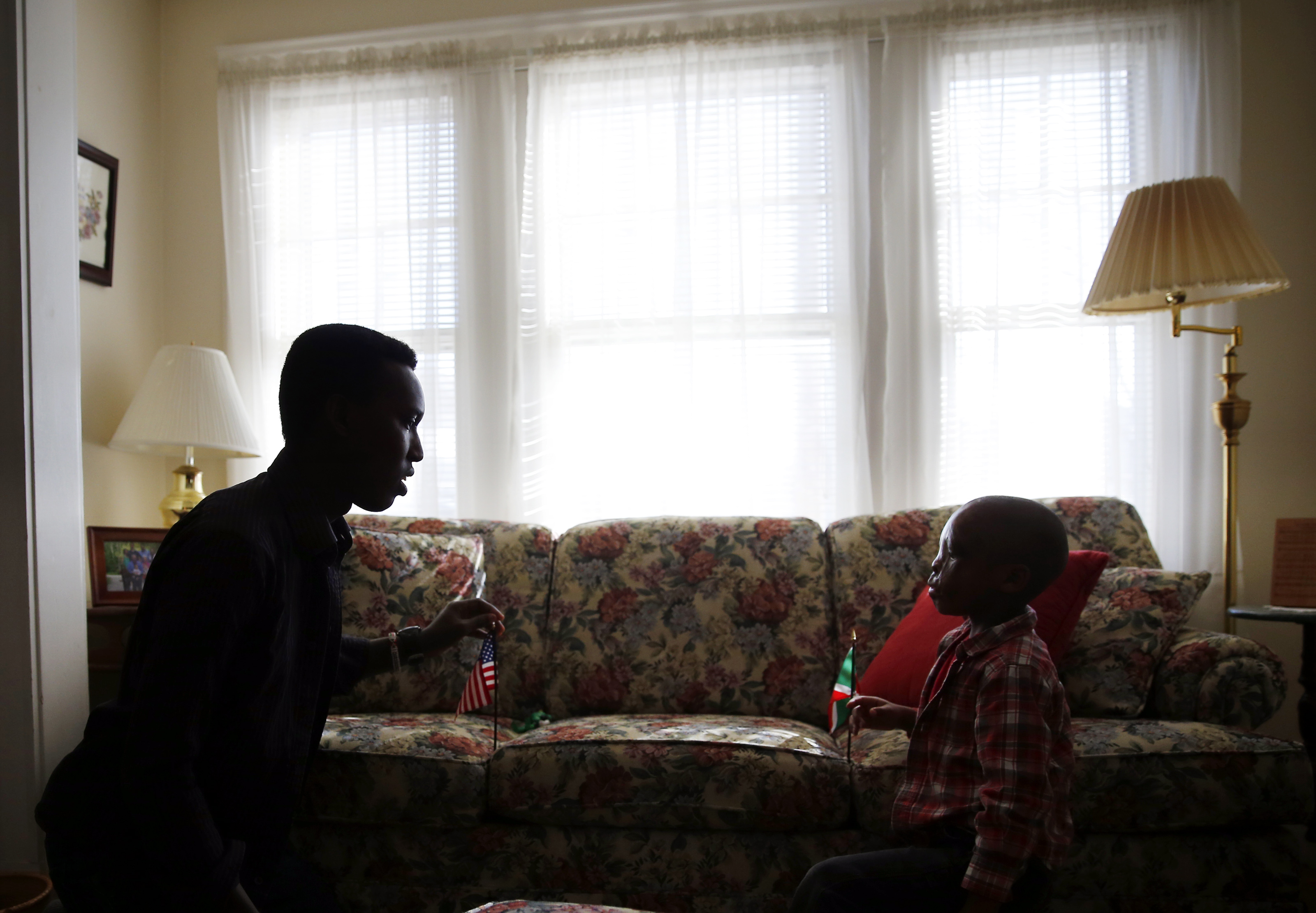 Alex Gitungano (left) had little parenting experience when he assumed full-time care of Leo Ikoribitangaza in the summer of 2014.