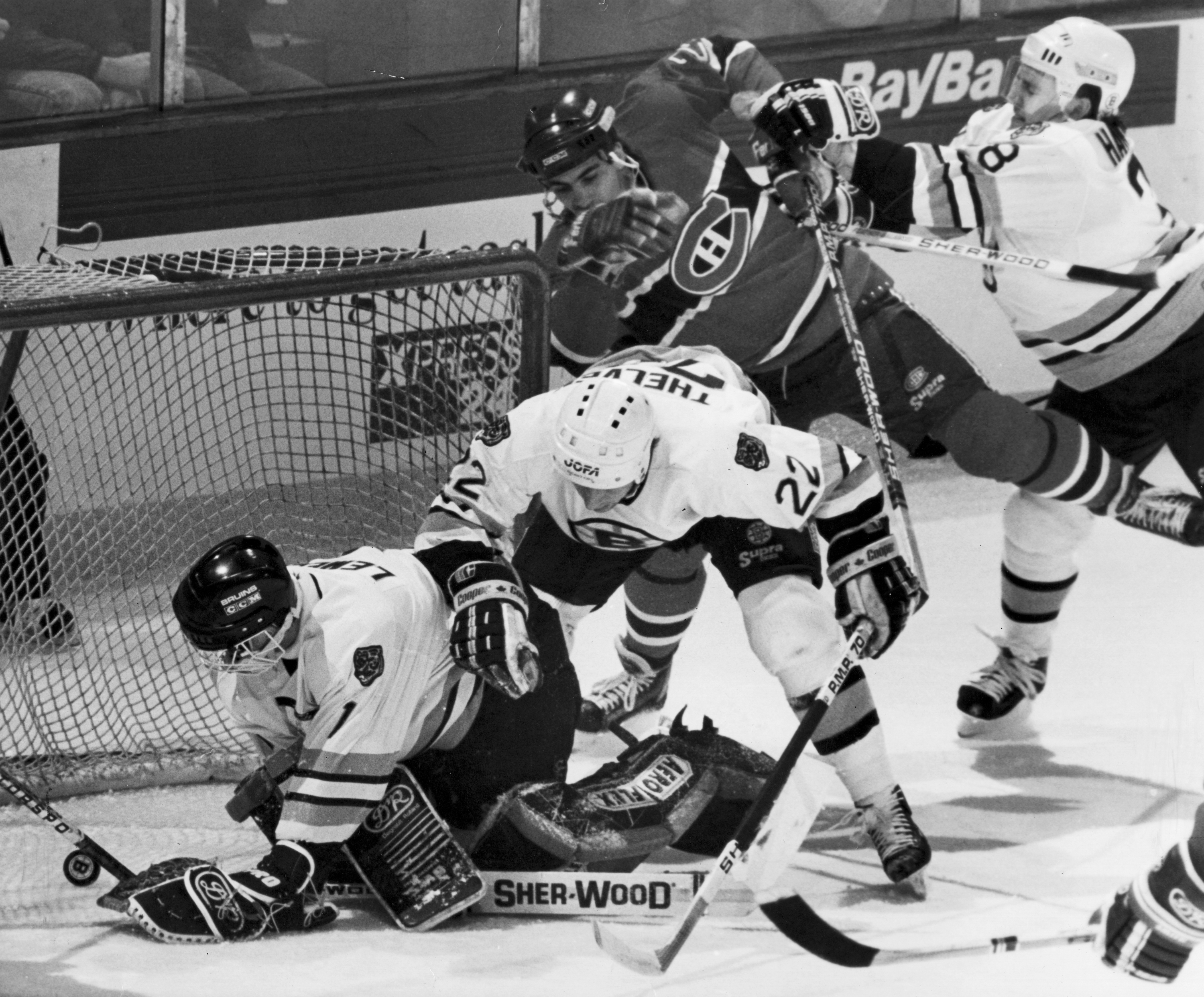 Michael Thelven (22) was never one to shy away from the gritty work of helping Bruins teammate Reggie Lemelin in net.
