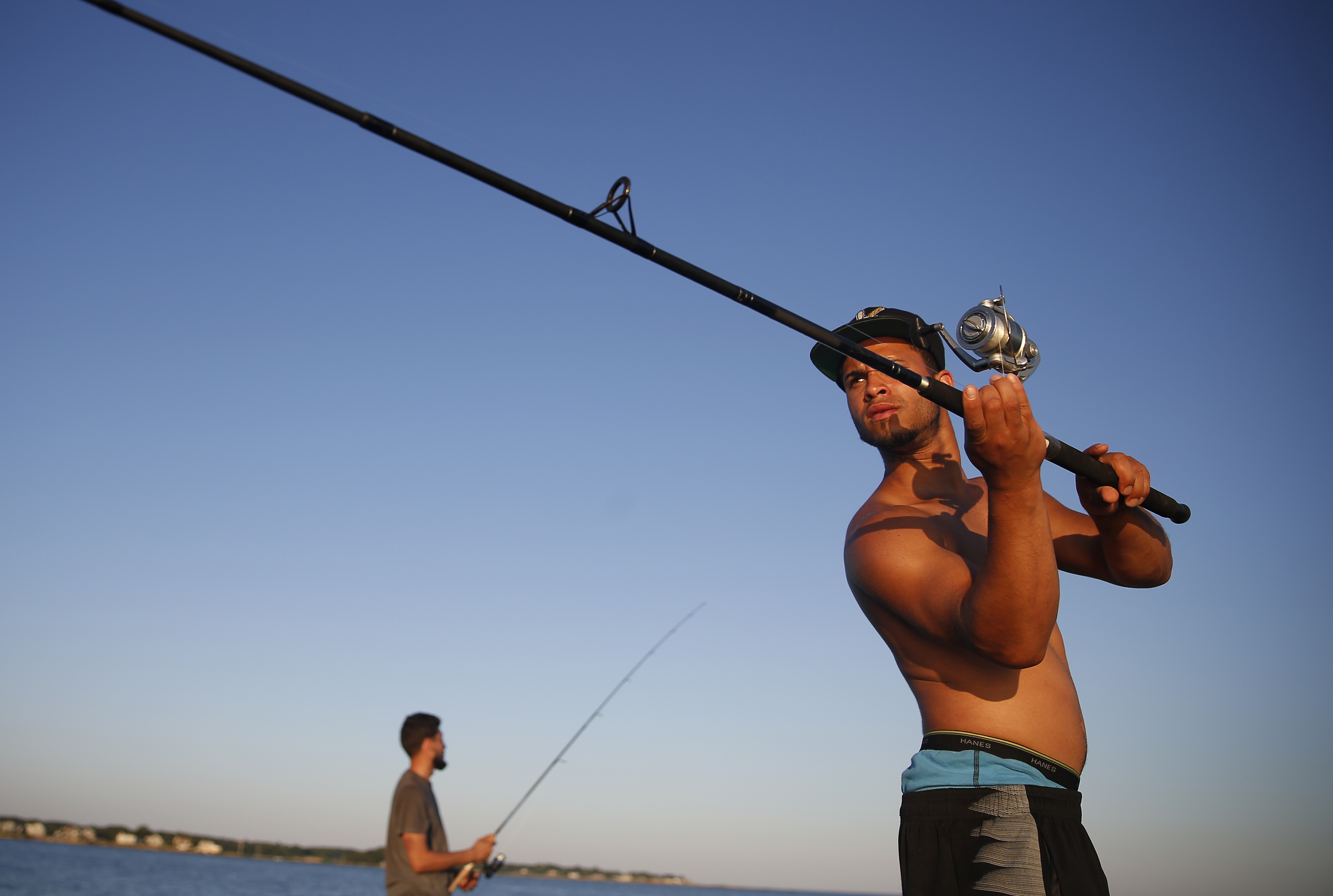 Josua Gonzalez of Springfield casts for striped bass at Rocky Neck State Park in East Lyme, Connecticut.