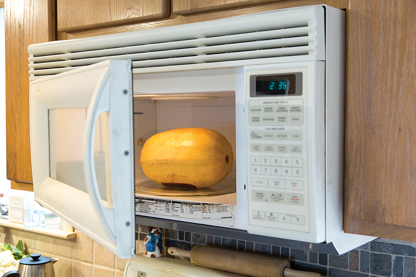 Cutting a raw spaghetti squash in half can be difficult, but a microwave eases matters. Pierce the squash four or five times with a fork or paring knife and microwave it whole for about 5 minutes. It will soften slightly, and when cool enough to handle can be halved with a little less effort.