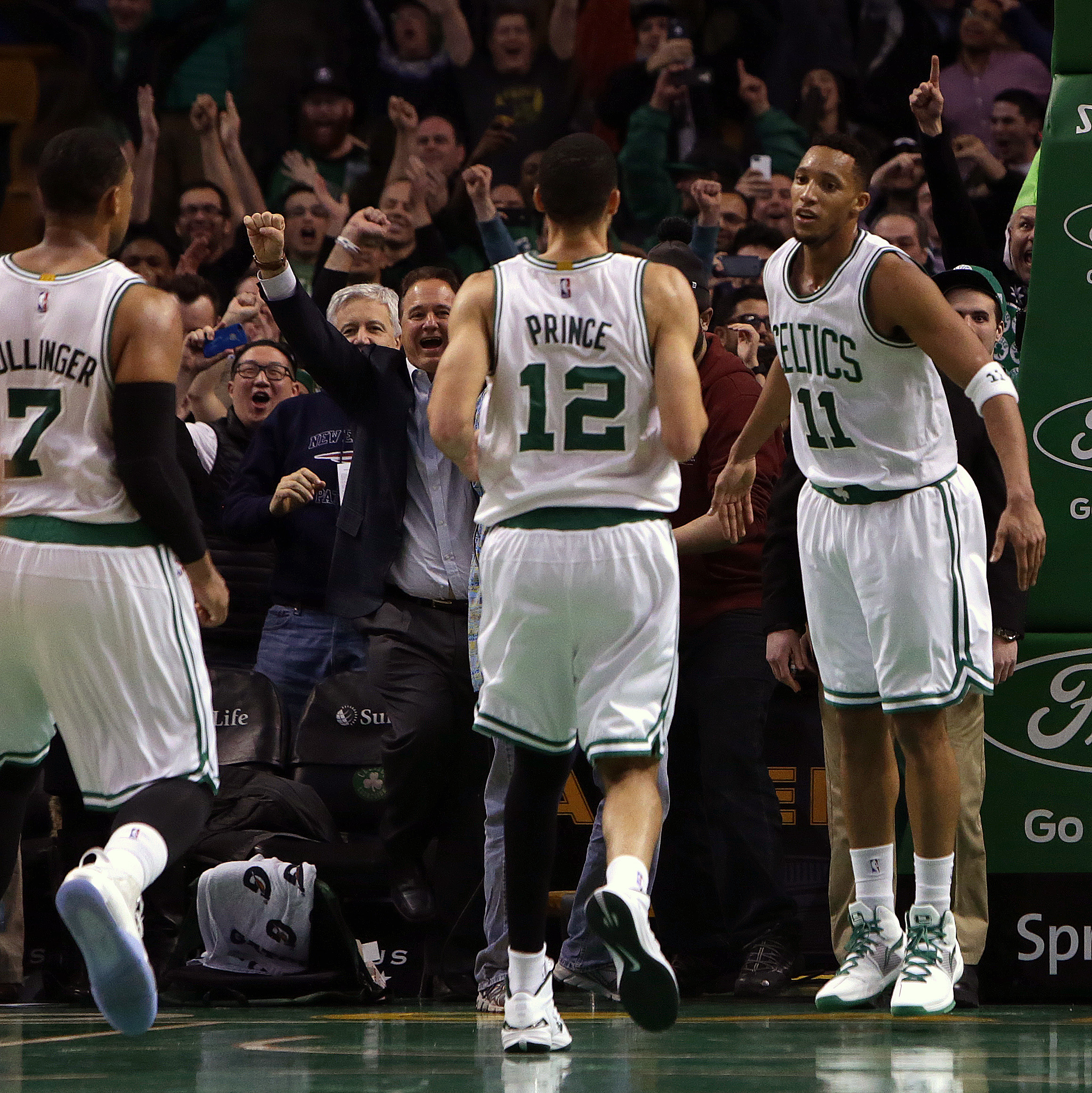 Celtics guard Evan Turner (11) and teammates celebrate the come from behind upset of the Atlanta Hawks.