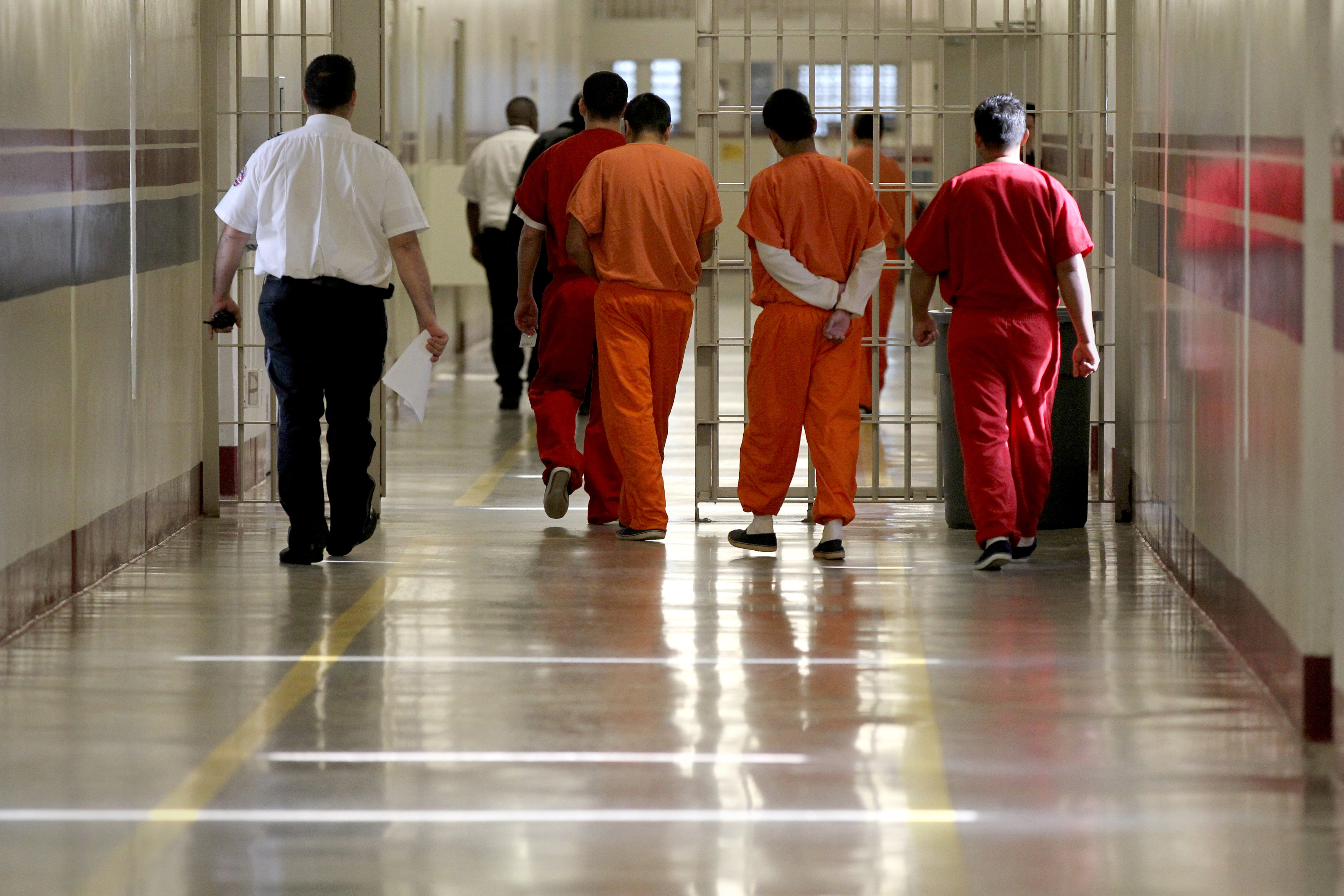 Detainees at Stewart Detention Center in Lumpkin, Ga., are escorted through a corridor. The rural area is one of the poorest in the state.