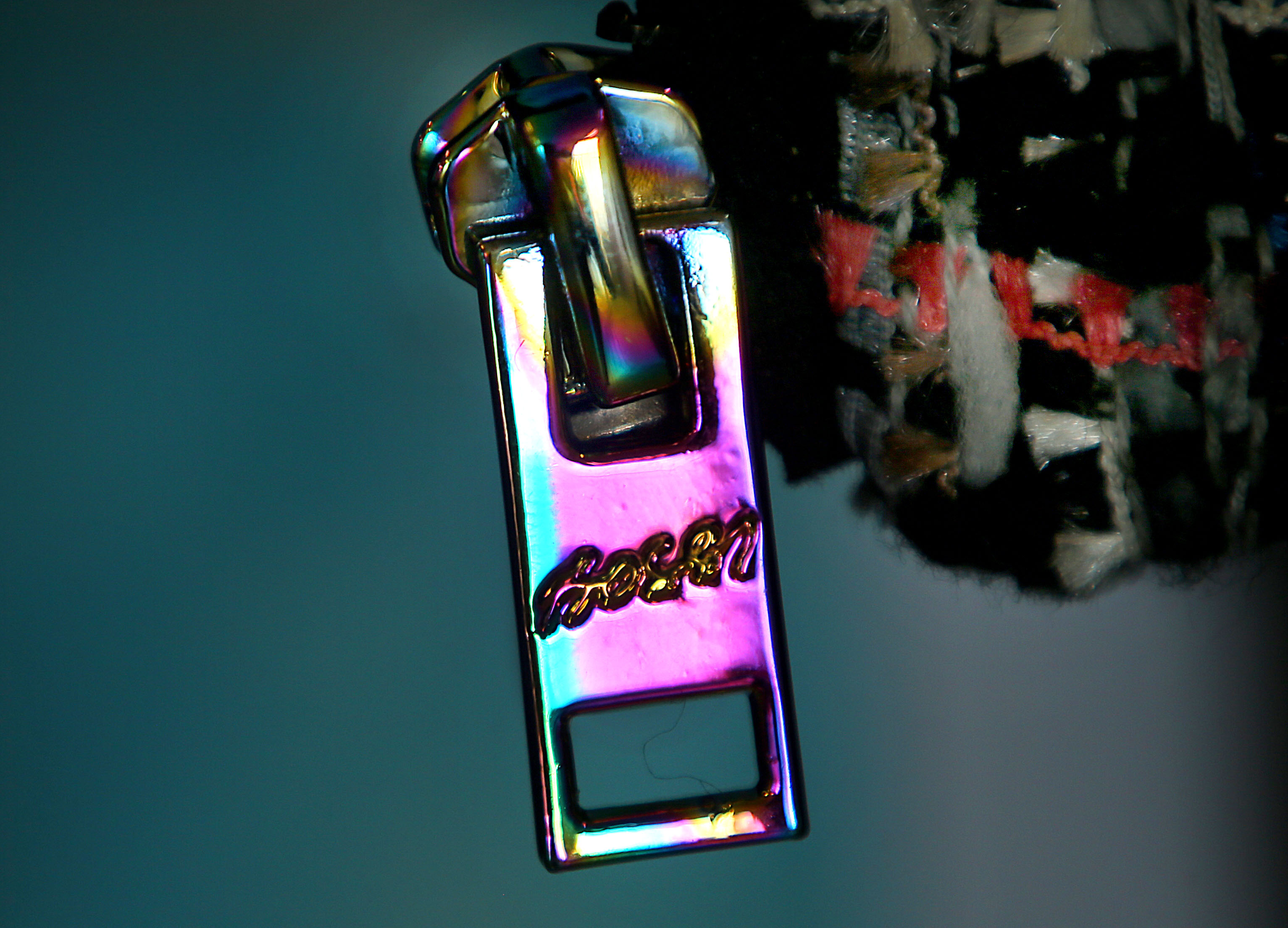 The iridescent zipper pulls, buttons, and accents Bossi uses are inspired by oil slicks you might see at an auto body shop.
