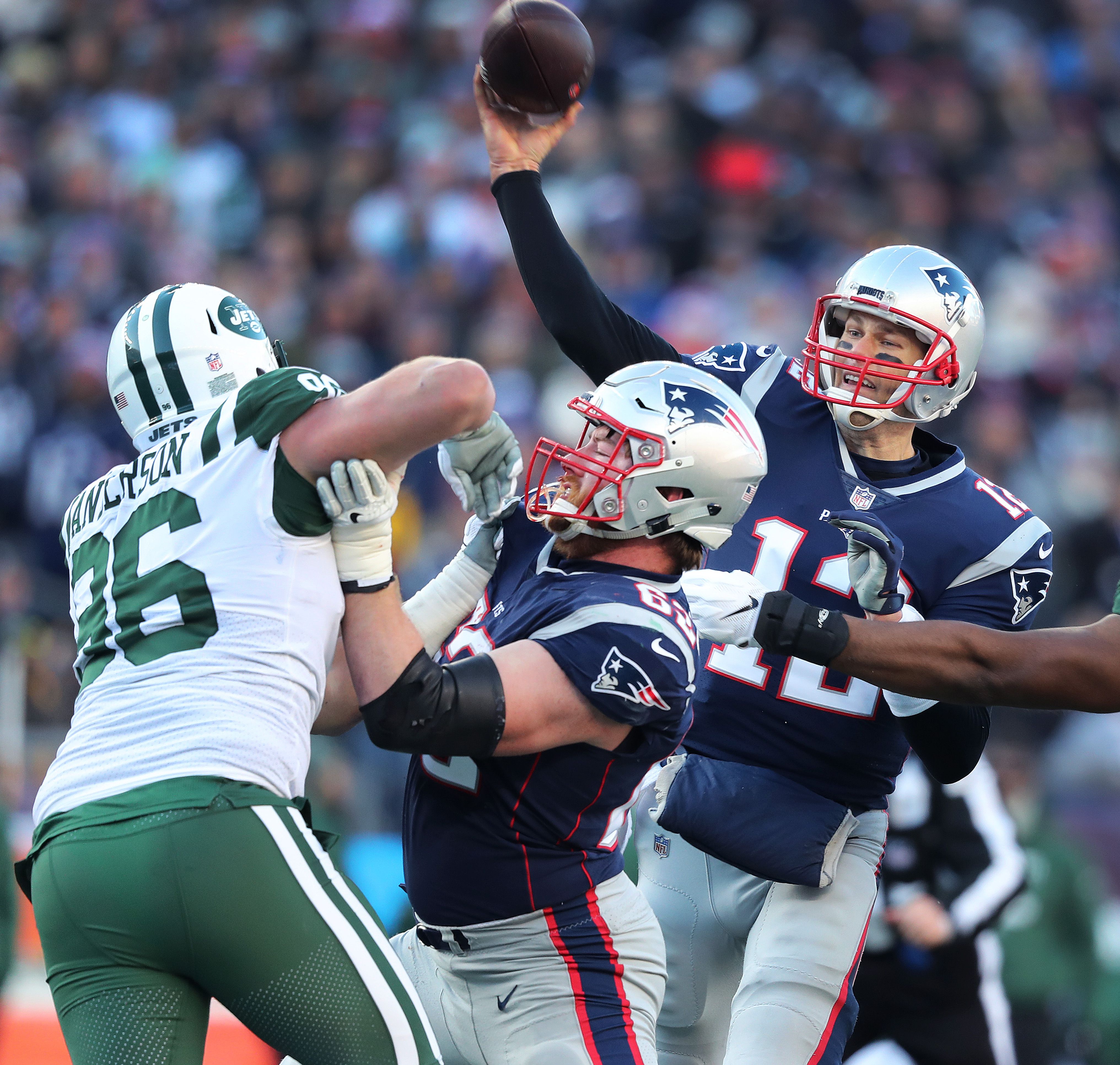 With the help of a block by OL Joe Thuney (62) Patriots quarterback Tom Brady gets off a second quarter pass.