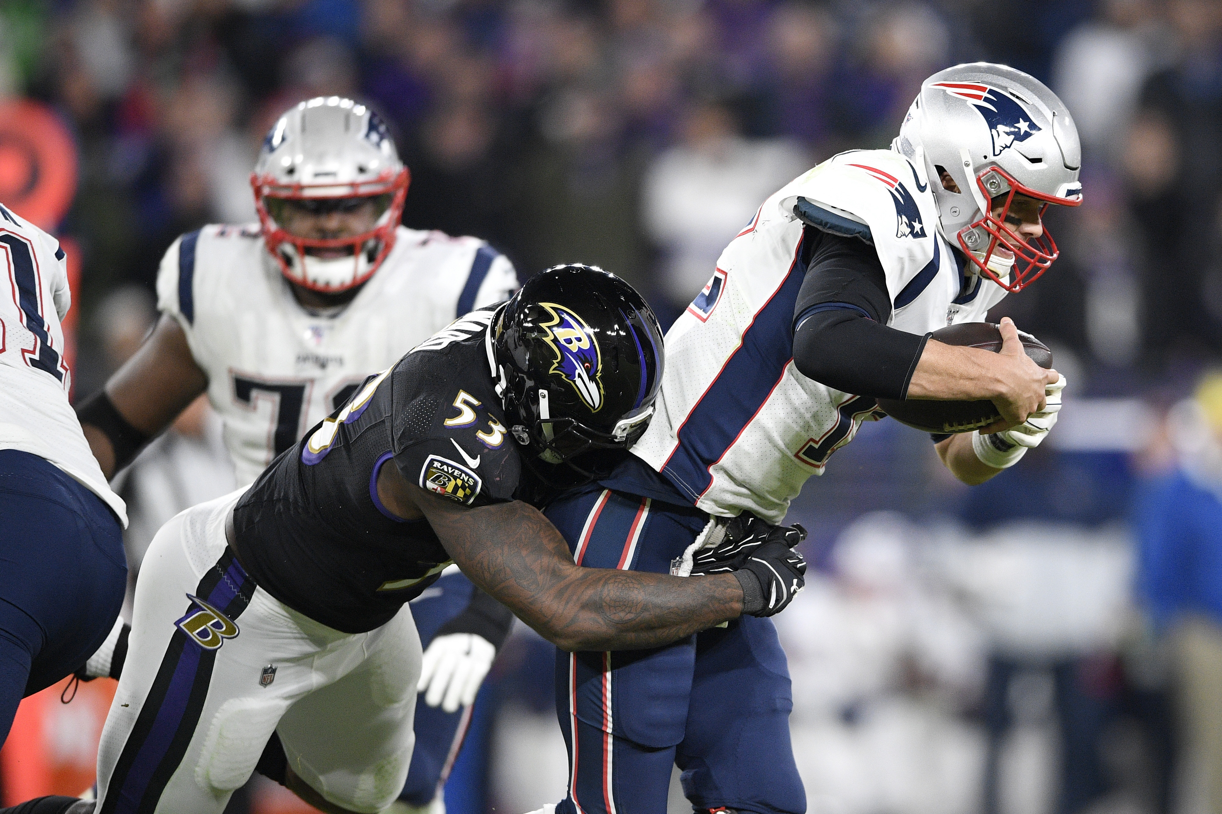 Baltimore‘s Jihad Ward sacks Tom Brady in the second half of Sunday’s game.