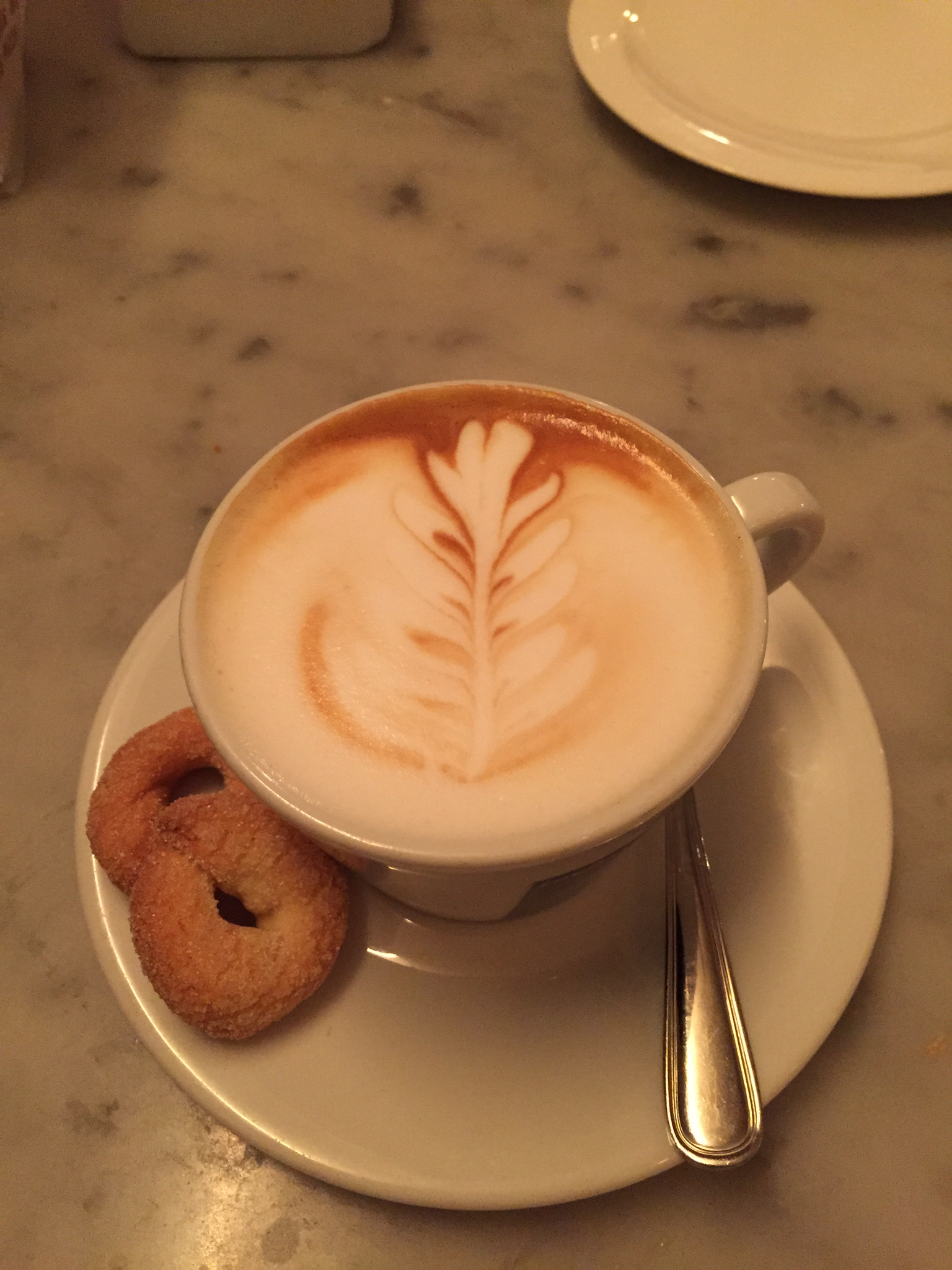 A cappuccino and tarallucci cookies at Tarallucci e Vino.