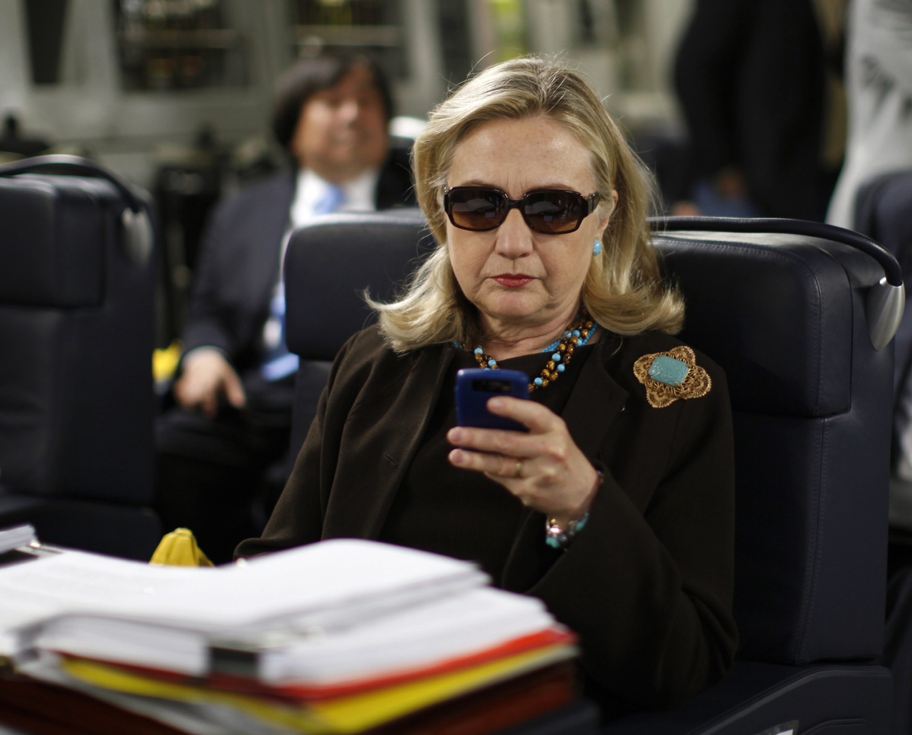 Then-Secretary of State Hillary Clinton checked her BlackBerry while on an overseas trip in October 2011.