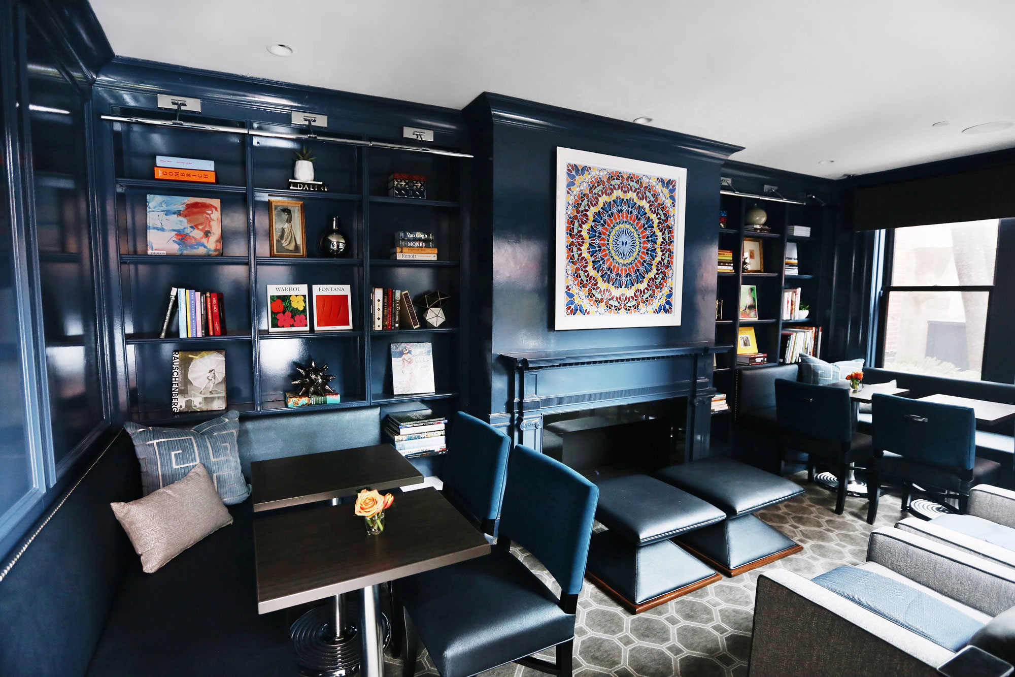 The new, snug library has built-in shelves filled with art books.