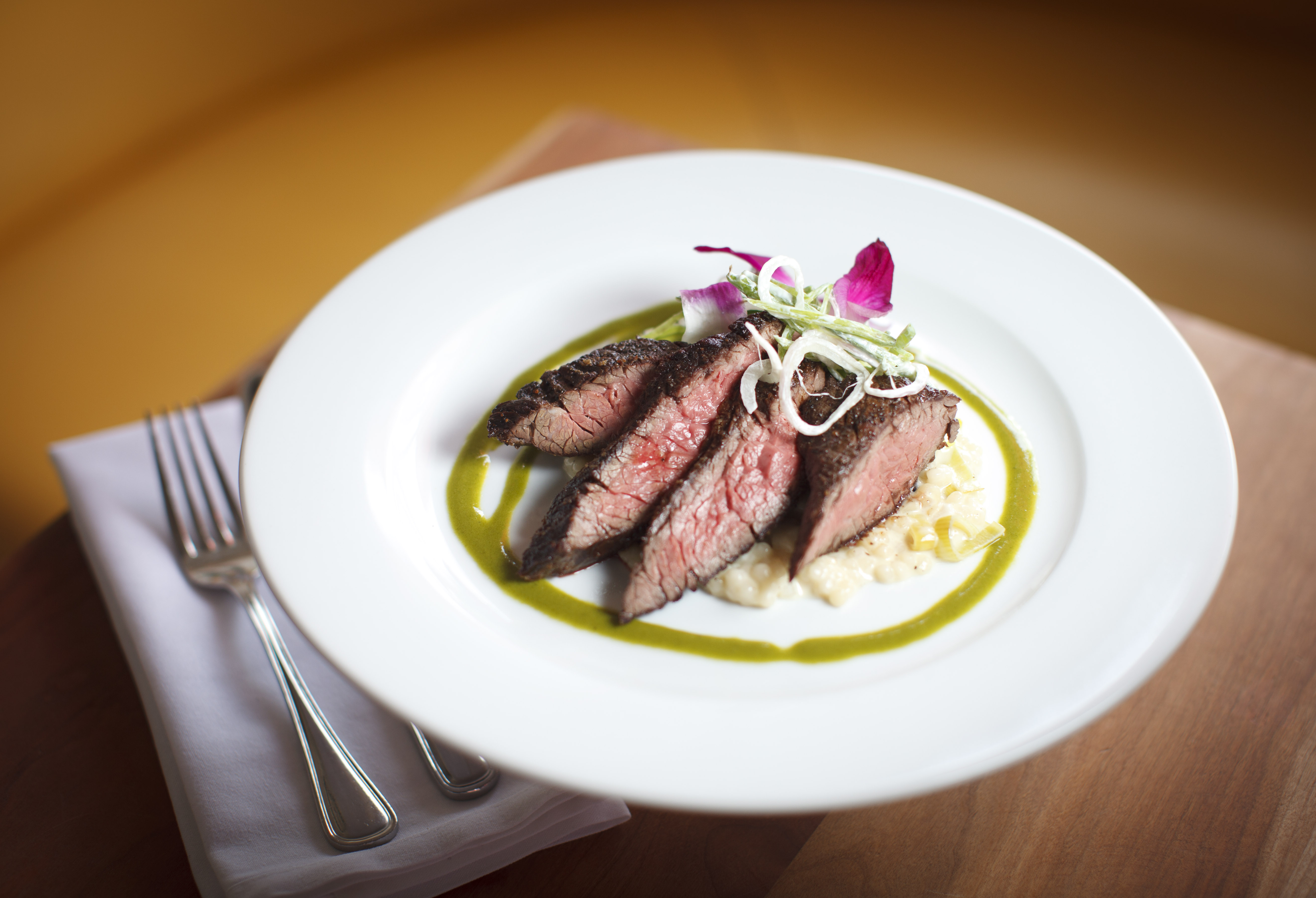 Hanger steak with leek and garlic couscous, bean salad.