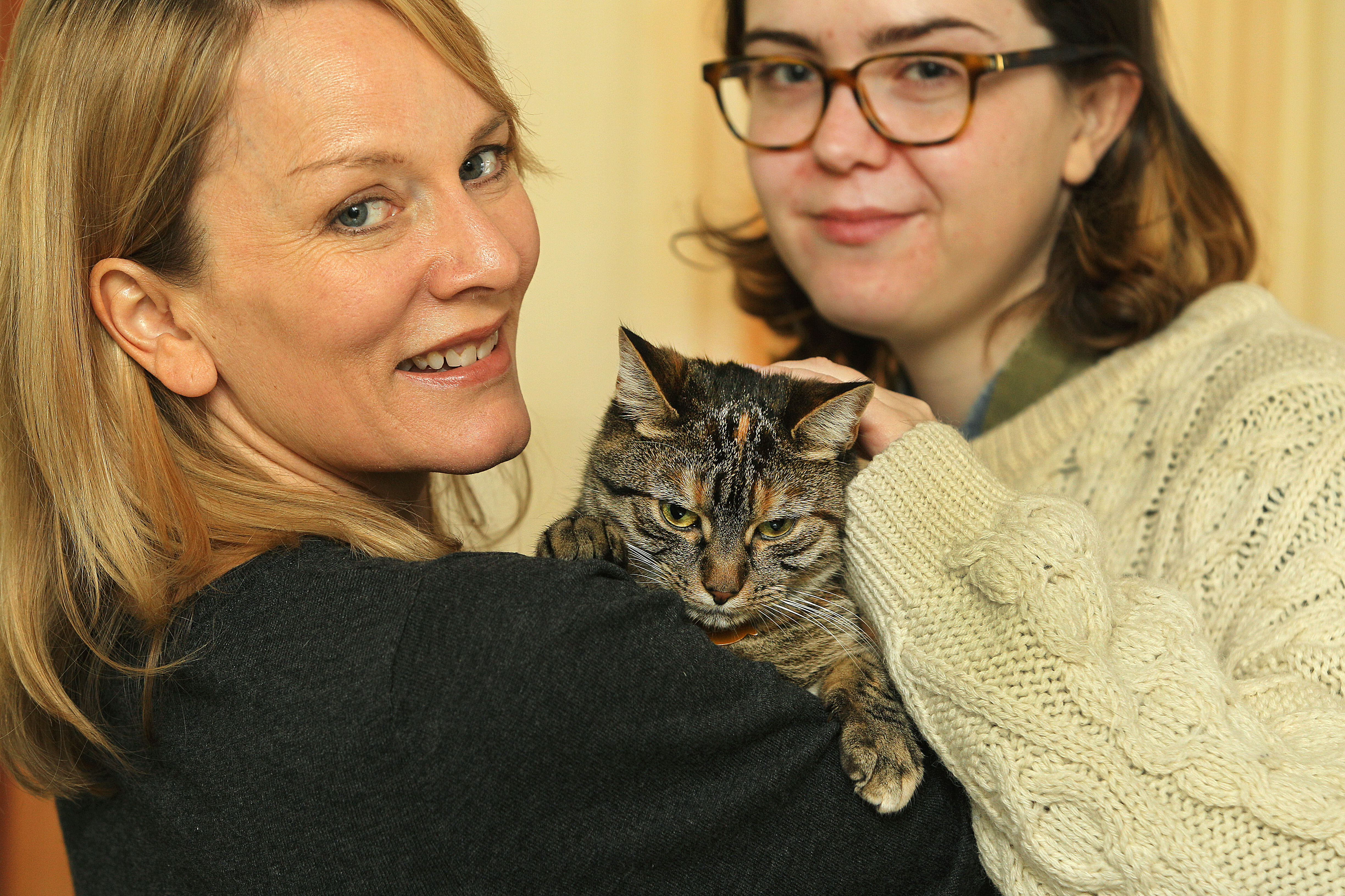 Rachel Strutt (left), program manager for the Somerville Arts Council, and intern Vera Vidal with Strutt’s cat, Coco.