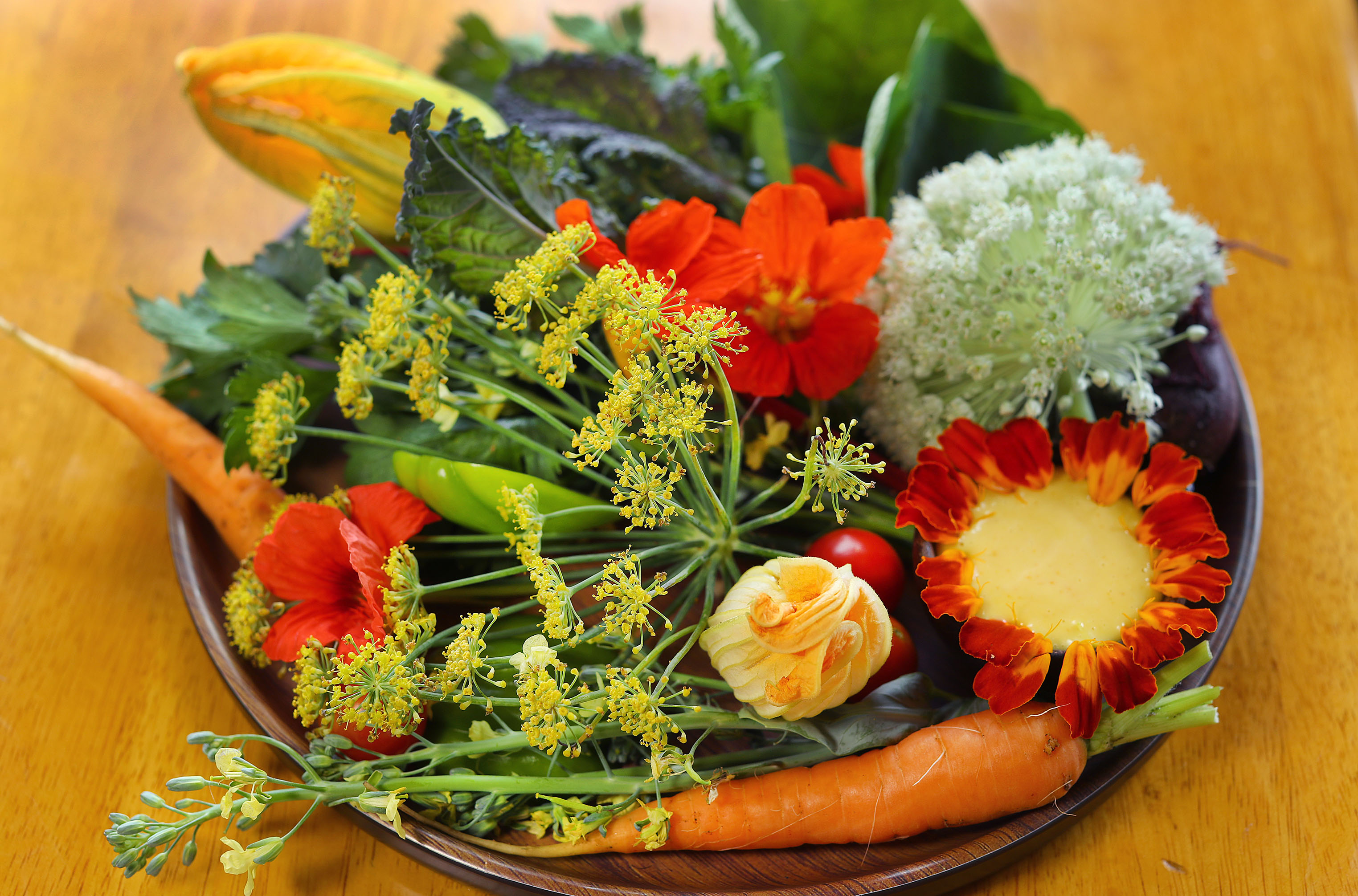 A crudite platter of farm vegetables and flowers with “aioli that tastes like sunshine.”
