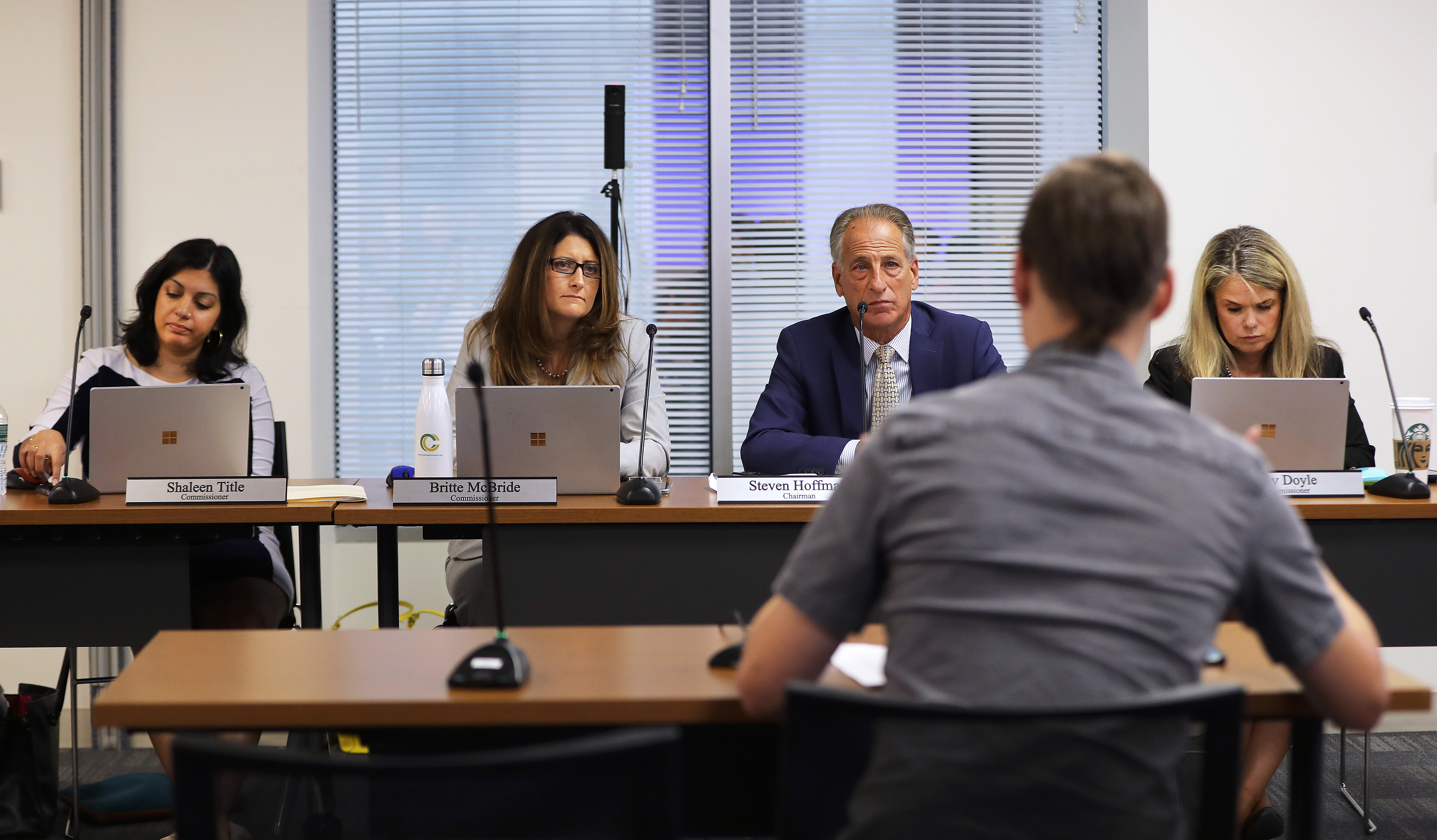 Cannabis Control Commissioners Shaleen Title, Britte McBride, Steven Hoffman, and Kay Doyle listened to testimony on Wednesday. If the agency gives final approval in September, marijuana deliveries could start within months.