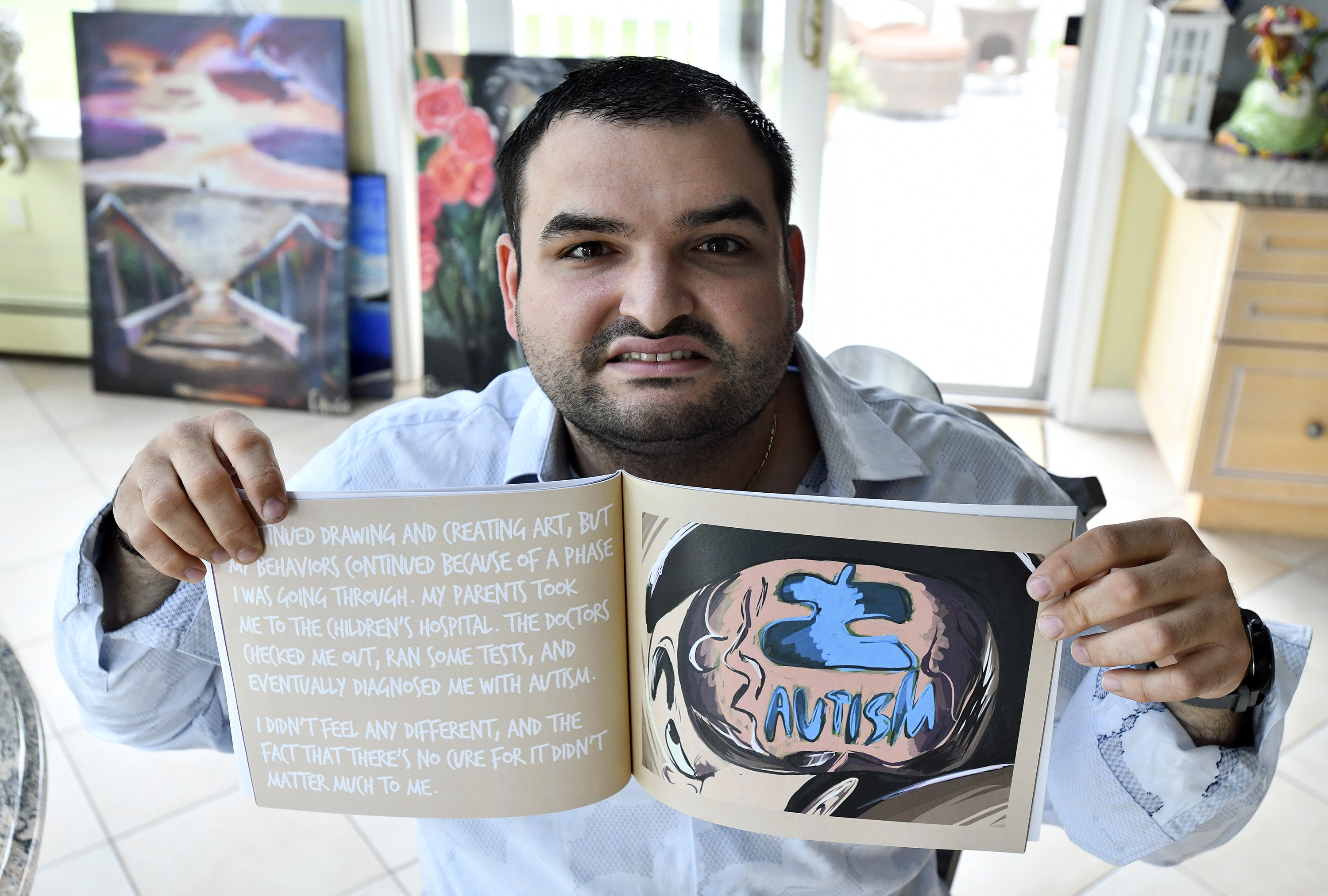 Polyvois Christoforos with the book he wrote, illustrated and published, "Sammy Smart Guy."