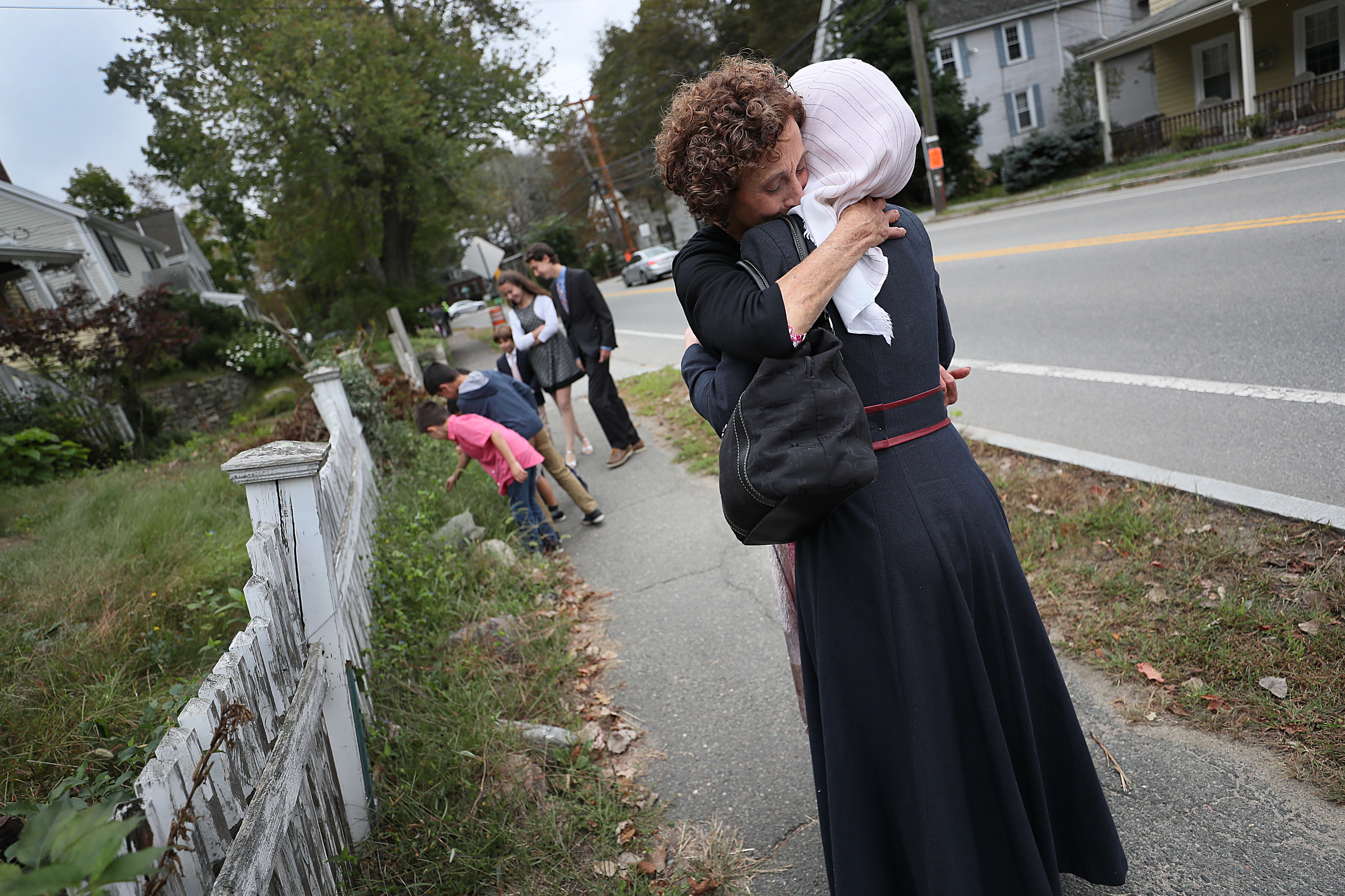 Bonnie Rosenberg, temple member and volunteer, paused to hug Asmaa Hayani on Yom Kippur.