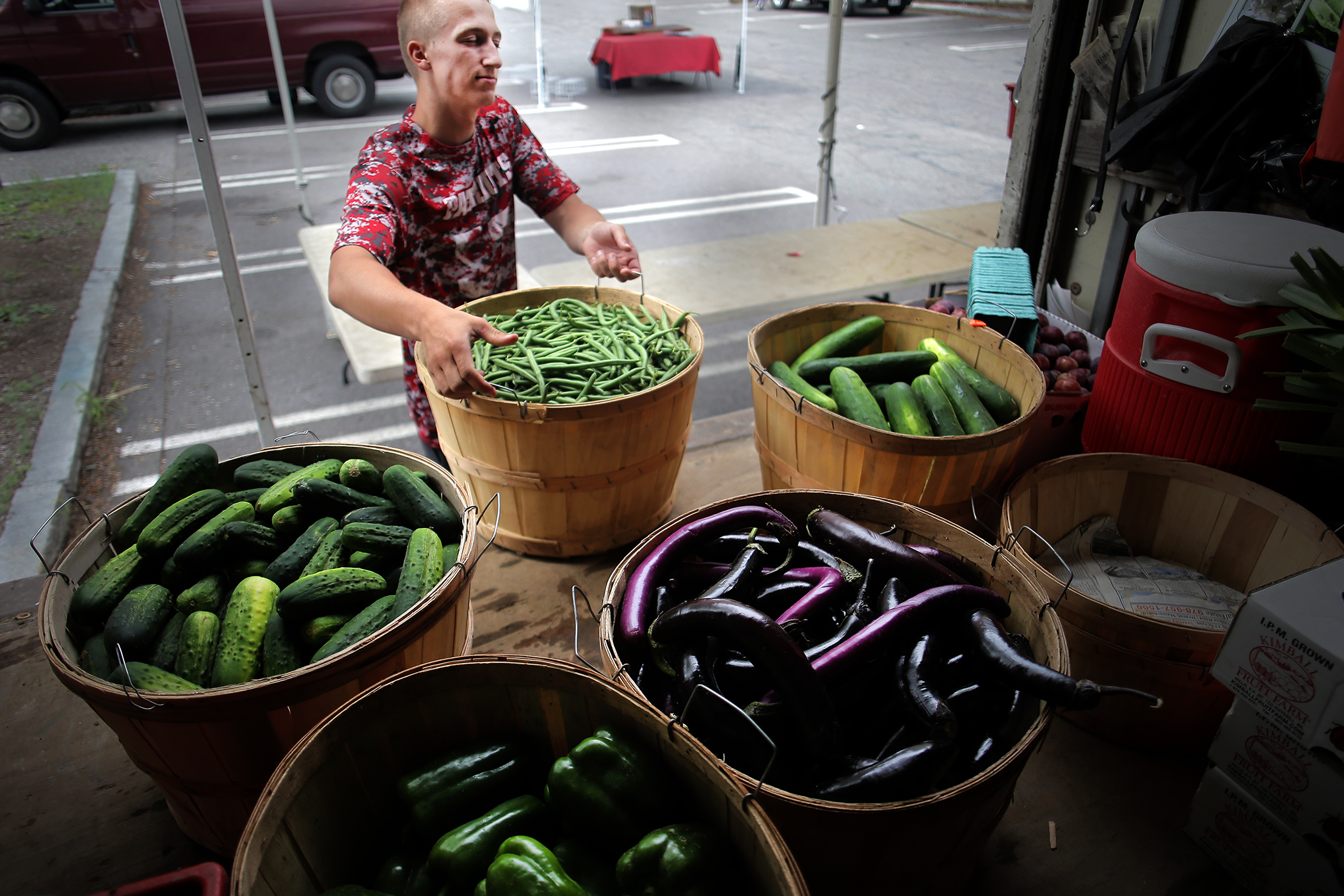 Kevin Bragg of Kimball Fruit Farm unloaded produce at the Brookline Farmers Market in Coolidge Corner.