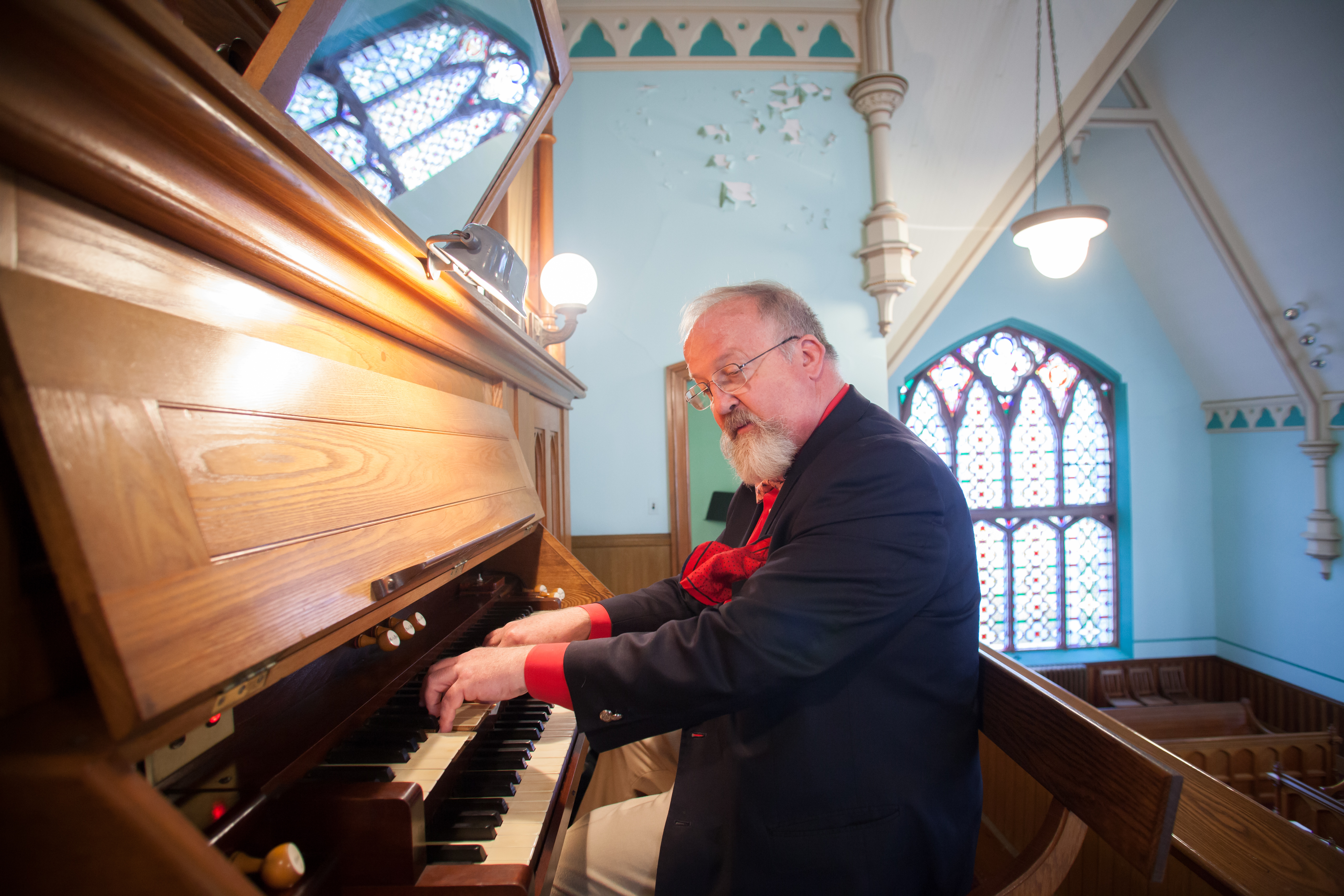 Peter Krasinski playing the historic organ inside the Stone Church in Gilbertville.