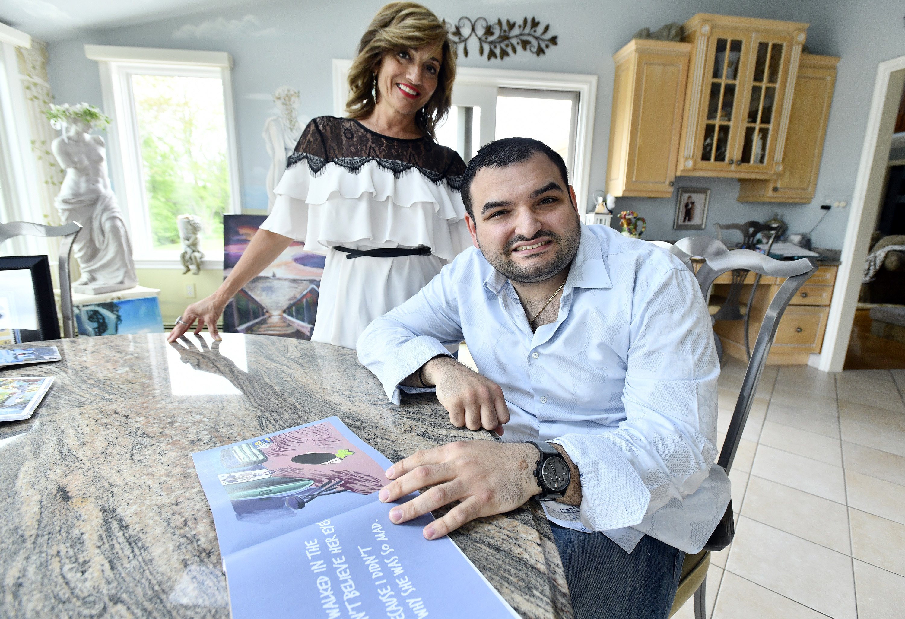 Polyvois Christoforos with his mother, Georgia Christoforos, and the book he wrote, illustrated and published, "Sammy Smart Guy."