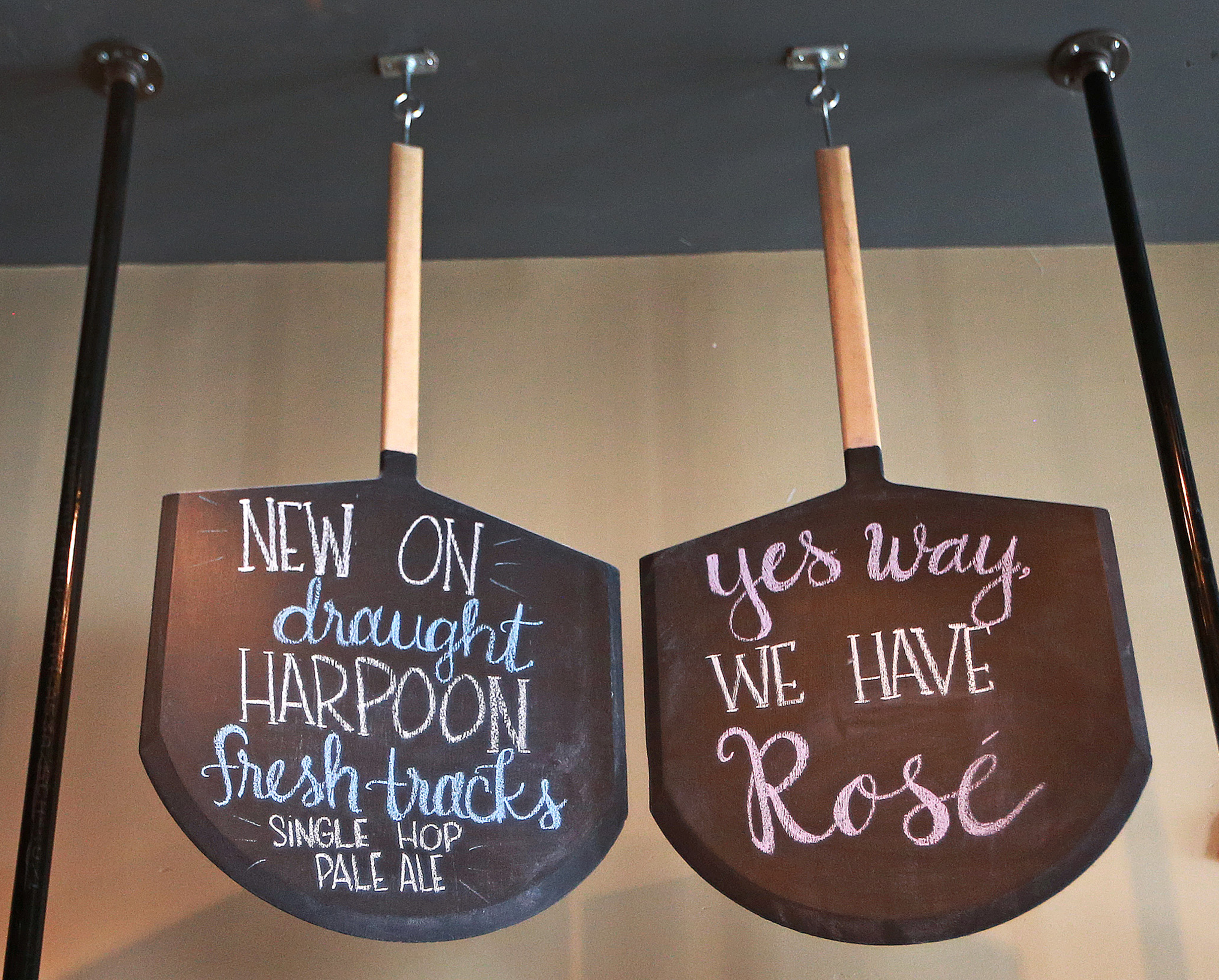 Pizza paddles used as chalkboards? Craft pizza must be near. This is at Max and Leo’s in Newton.