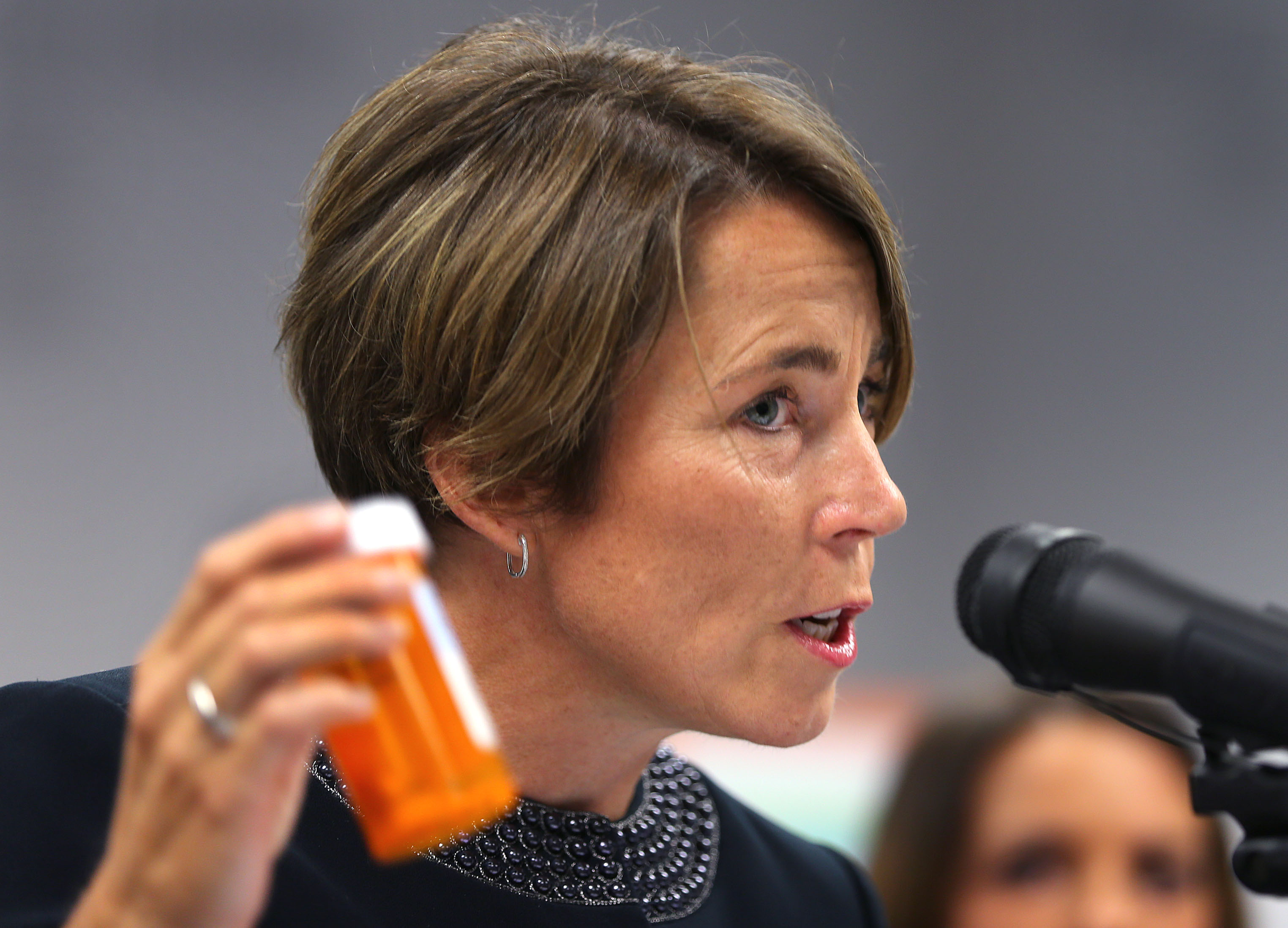 Attorney General Maura Healey holds a CVS prescription bottle as she announced last September a first-in-the-nation settlement with CVS Pharmacy to strengthen its policies and procedures for dispensing opiods.